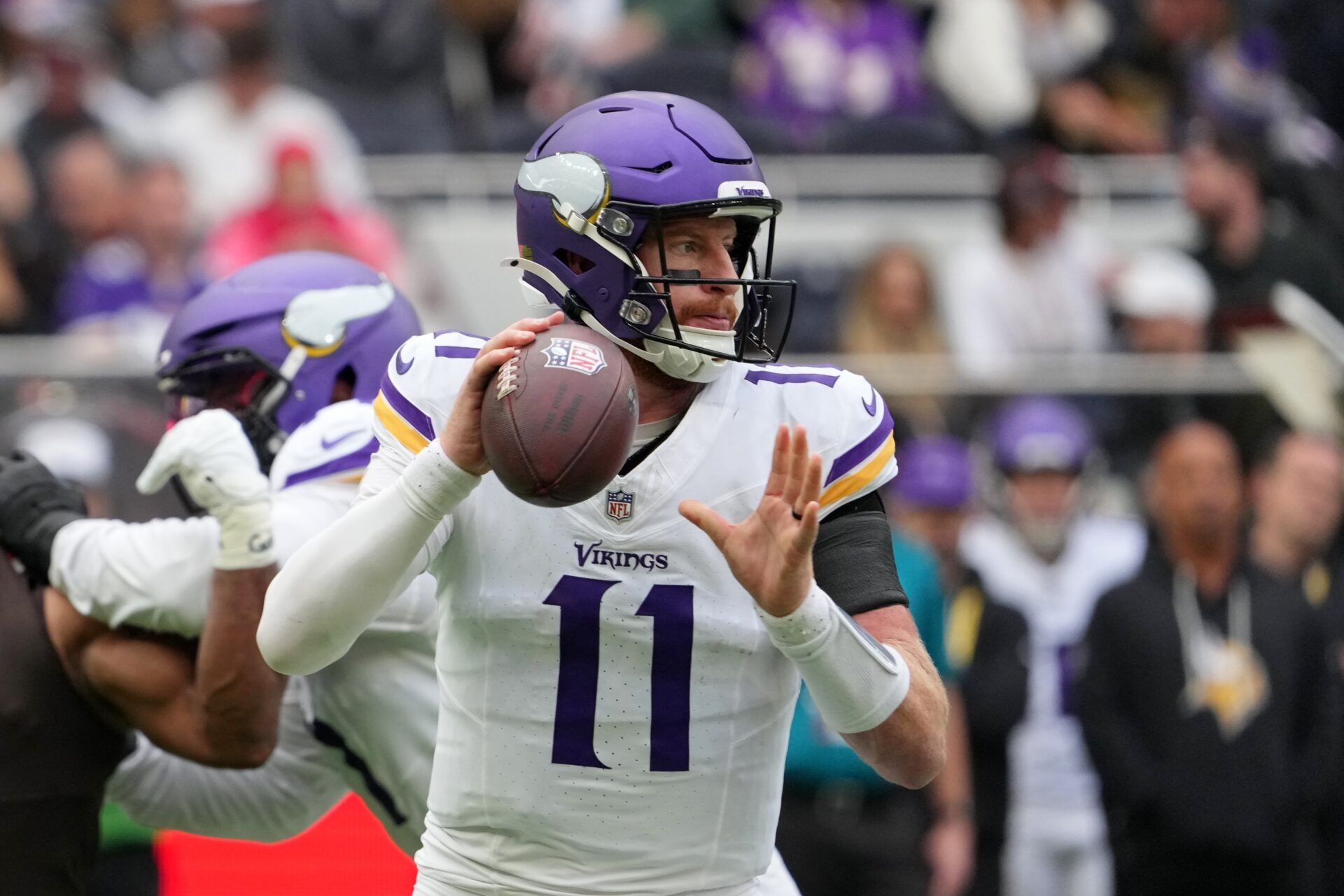 Minnesota Vikings quarterback Carson Wentz (11) looks to pass the ball against the Cleveland Browns during the third quarter of an NFL International Series game at Tottenham Hotspur Stadium.