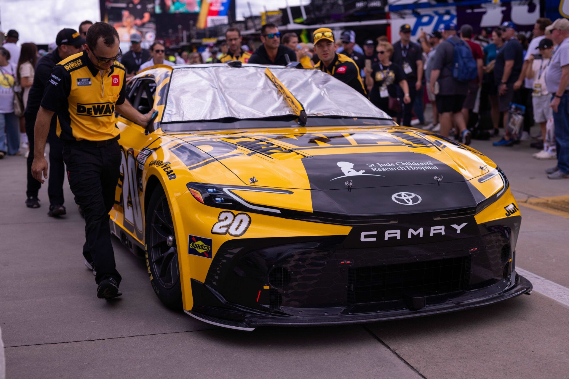Fans watch as cars are moved to the grid at Charlotte Motor Speedway Road Course.