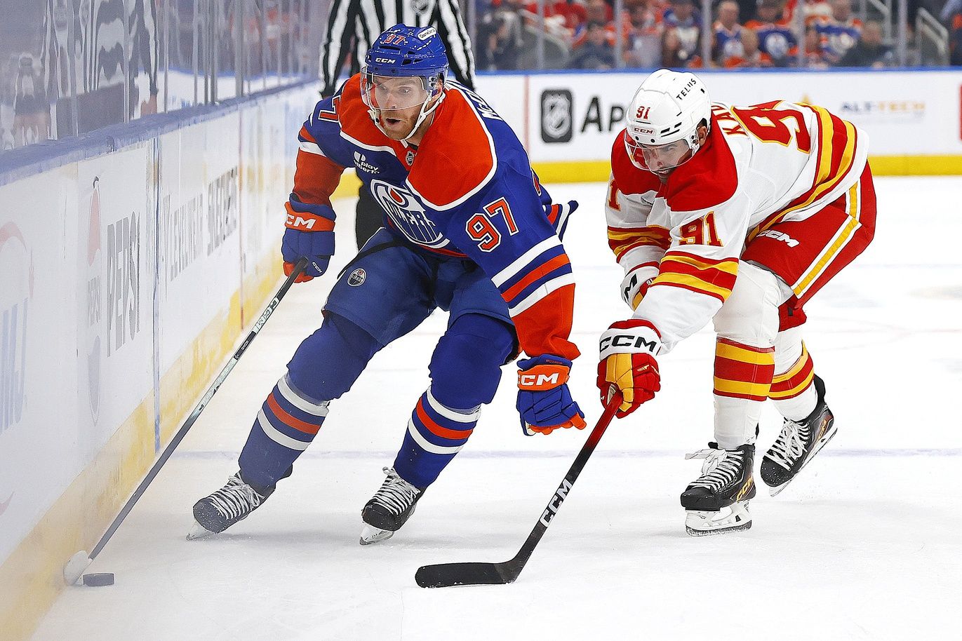 Edmonton Oilers forward Connor McDavid (97) carries the puck around Calgary Flames forward Name Kadri (91) during the first period at Rogers Place.
