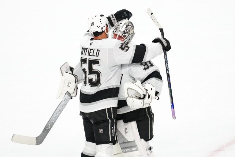 Los Angeles Kings right wing Quinton Byfield (55) celebrates with Los Angeles Kings goaltender Anton Forsberg (31) after the Kings defeated the Vegas Golden Knights 6-5 in a shoot-out at T-Mobile Arena.