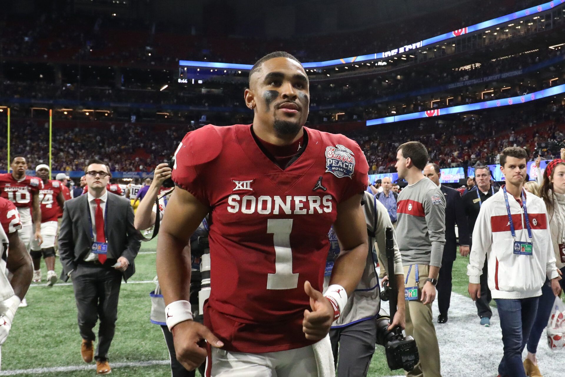 Oklahoma Sooners quarterback Jalen Hurts (1) runs off the field after the 2019 Peach Bowl college football playoff semifinal game between the LSU Tigers and the Oklahoma Sooners at Mercedes-Benz Stadium.