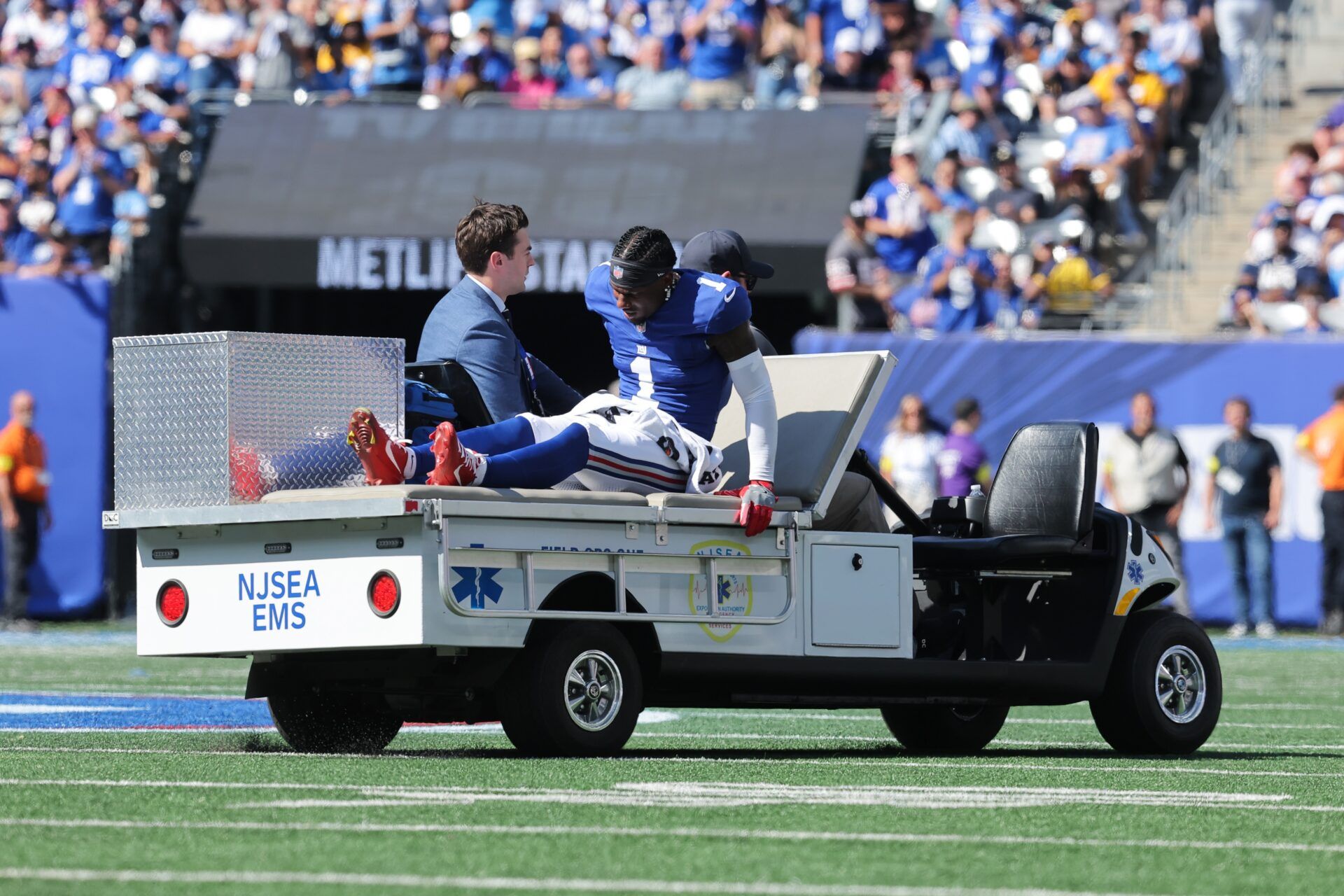 New York Giants wide receiver Malik Nabers (1) is carted off the field following an injury during the second quarter against the Los Angeles Chargers at MetLife Stadium.