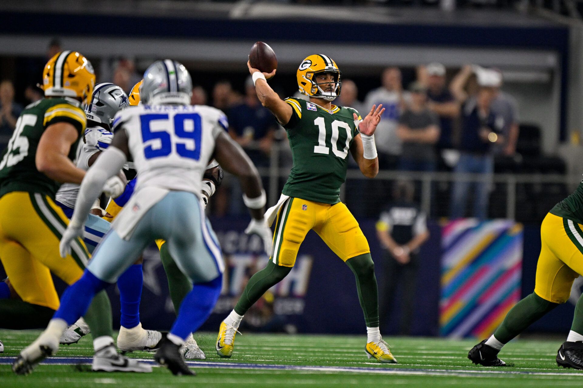Green Bay Packers quarterback Jordan Love (10) passes the ball during the game between the Dallas Cowboys and the Green Bay Packers at AT&T Stadium.