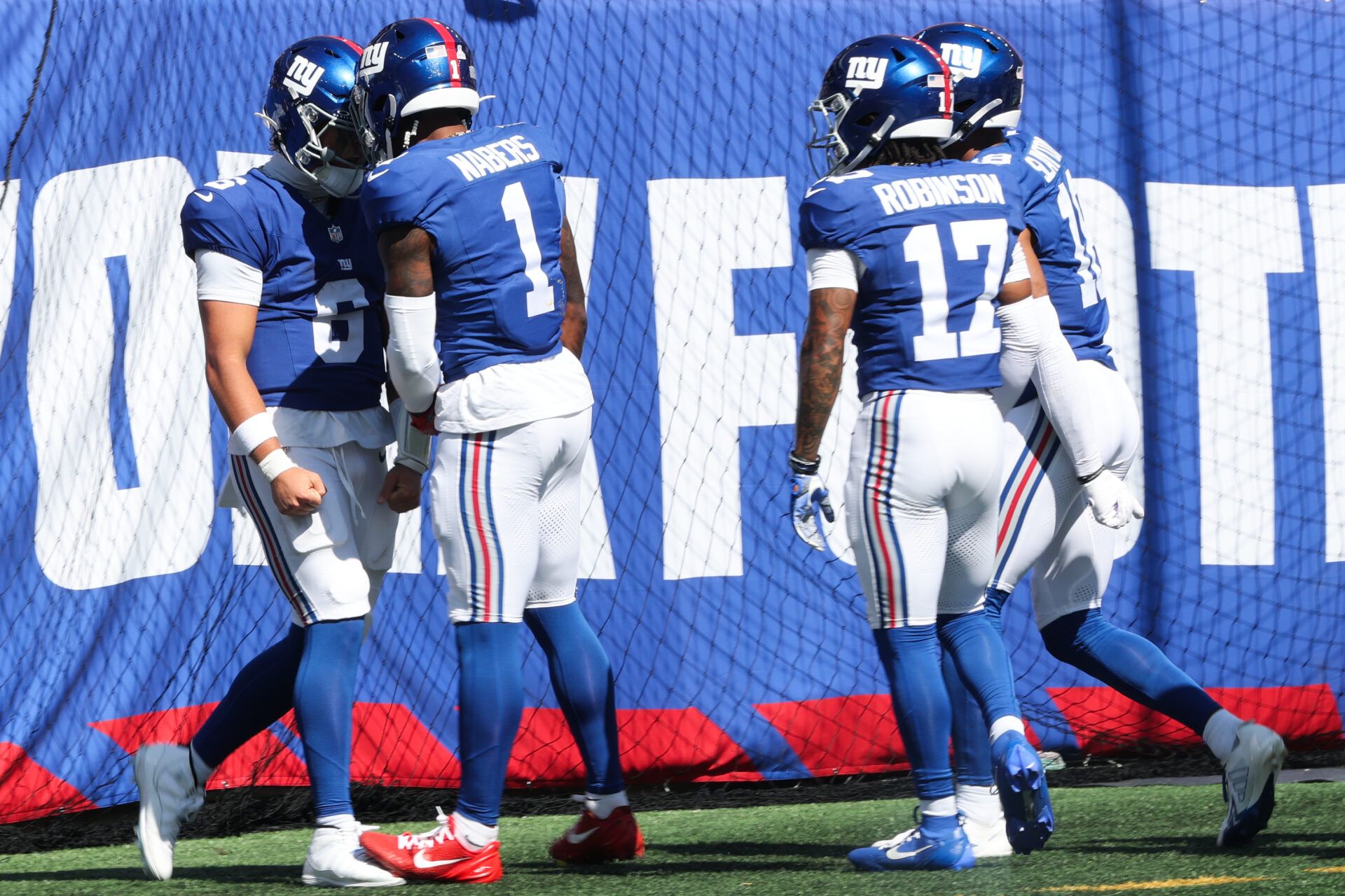 New York Giants quarterback Jaxson Dart (6) celebrates with New York Giants wide receiver Malik Nabers (1) after scoring a touchdown during the first quarter against the Los Angeles Chargers at MetLife Stadium.