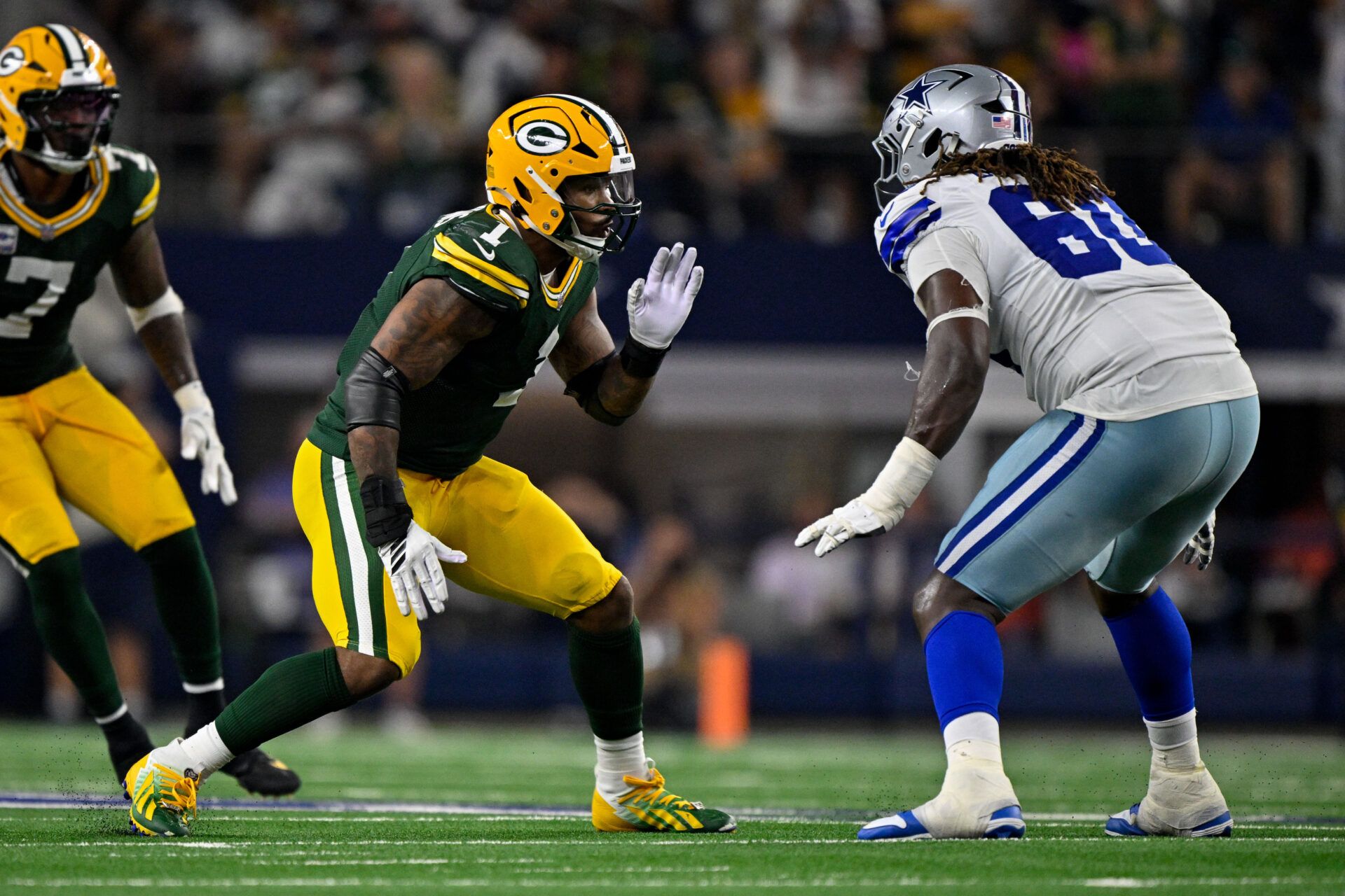 Dallas Cowboys offensive tackle Tyler Guyton (60) drops back to block the rush of Green Bay Packers defensive end Micah Parsons (1) during the game between the Dallas Cowboys and the Green Bay Packers at AT&T Stadium.