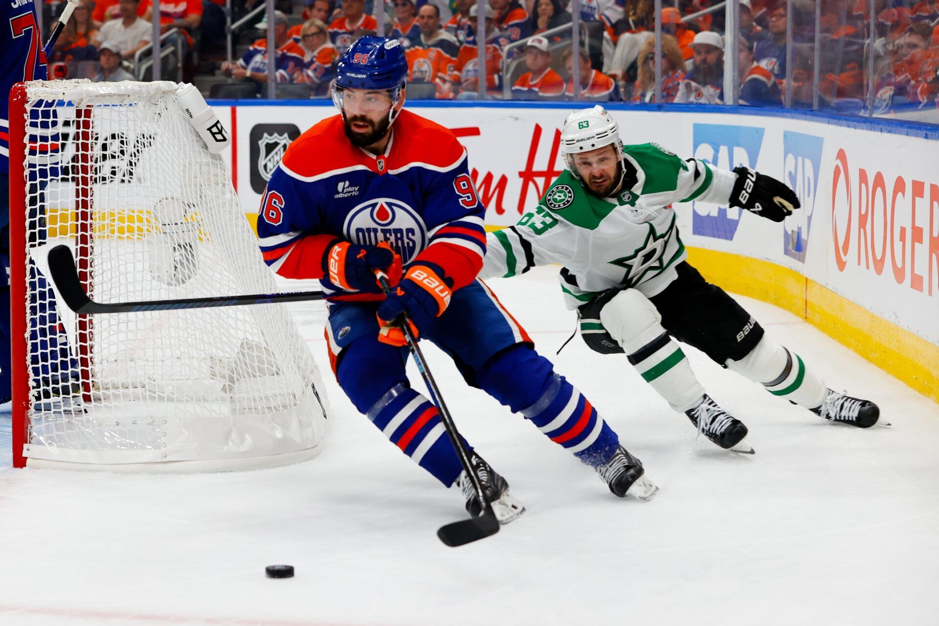 Edmonton Oilers defenseman Jake Walman (96) keeps the puck away from Dallas Stars right wing Evgenii Dadonov (63) in game three of the Western Conference Final of the 2025 Stanley Cup Playoffs at Rogers Place.