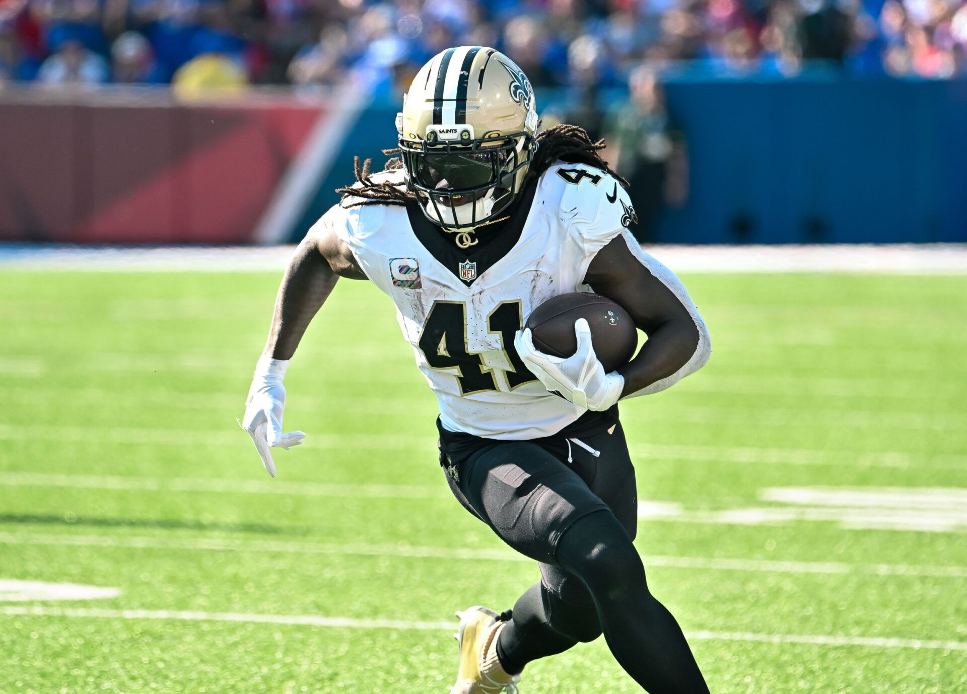 New Orleans Saints running back Alvin Kamara (41) carries the ball against the Buffalo Bills in the third quarter at Highmark Stadium.