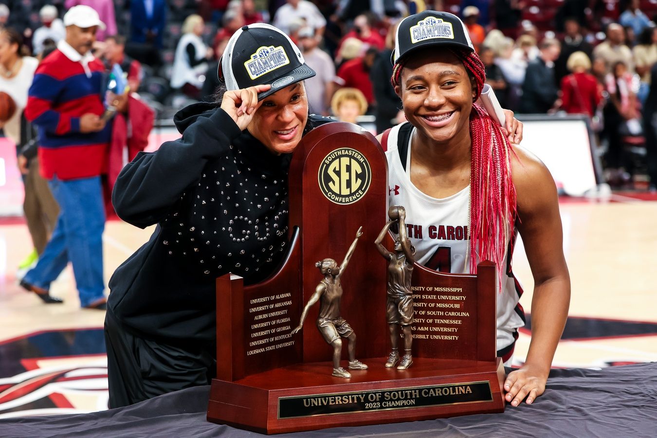 South Carolina Gamecocks head coach Dawn Staley and forward Aliyah Boston (4) pose with the 2023 SEC Regular Season Championship trophy following their win over the Georgia Lady Bulldogs at Colonial Life Arena.
