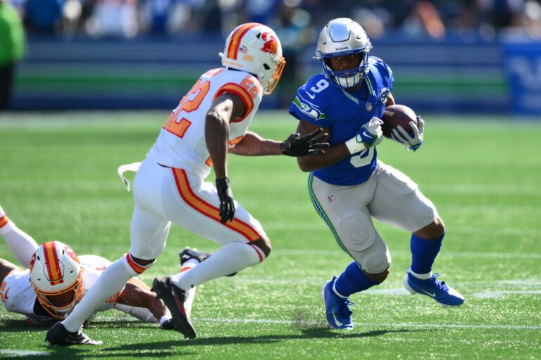 Seattle Seahawks running back Kenneth Walker III (9) carries the ball as. Tampa Bay Buccaneers cornerback Kindle Vildor (22) defends during the first half at Lumen Field.