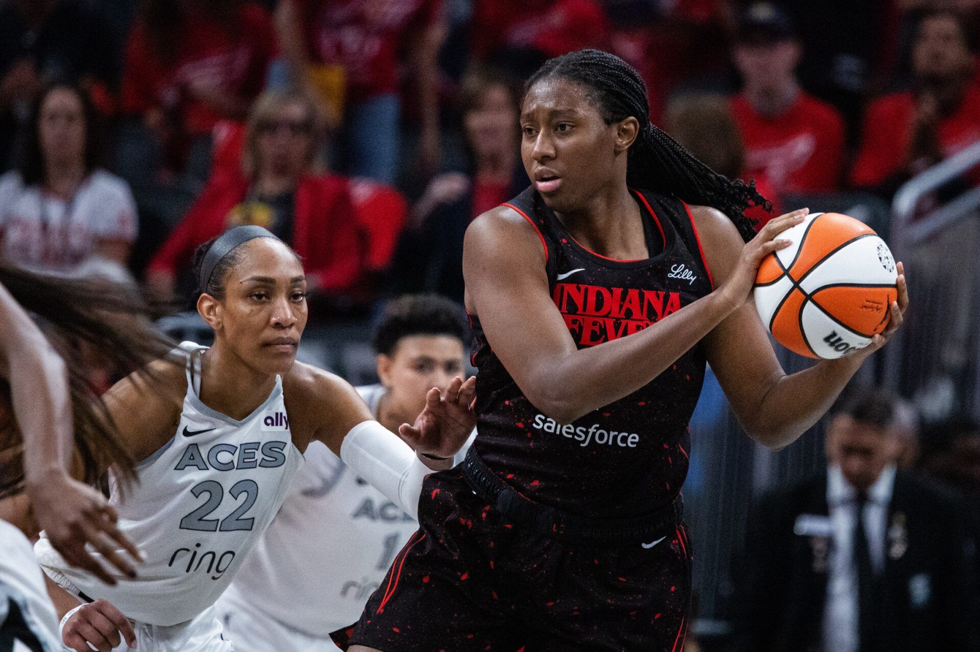 Indiana Fever forward Aliyah Boston (7) holds the ball while Las Vegas Aces center A'ja Wilson (22) defends in the second half  during game four of the second round for the 2025 WNBA Playoffs at Gainbridge Fieldhouse.