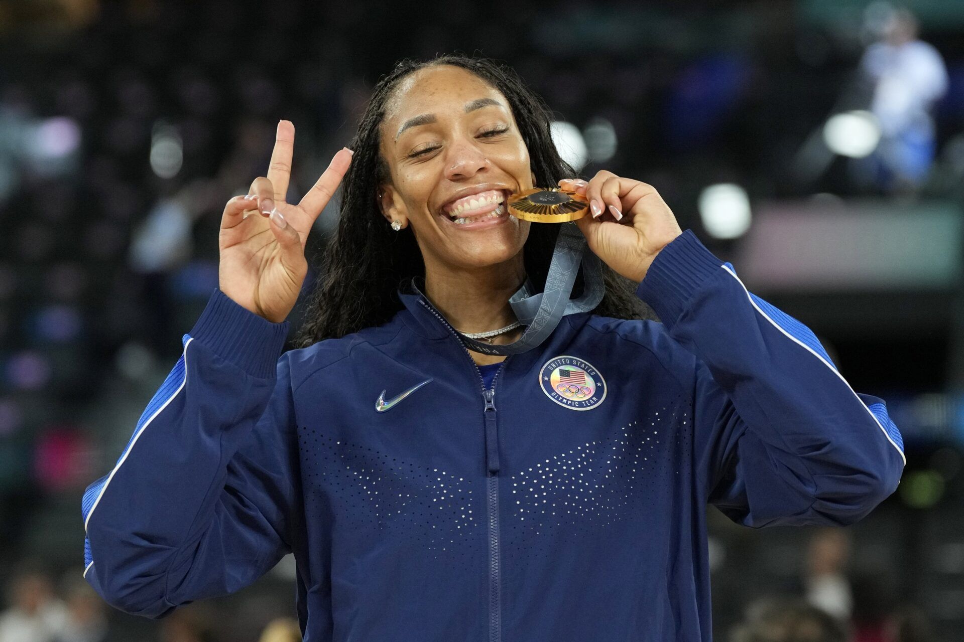 United States forward A'Ja Wilson (9) celebrates with the gold medal after defeating France in the women's gold medal game during the Paris 2024 Olympic Summer Games at Accor Arena.