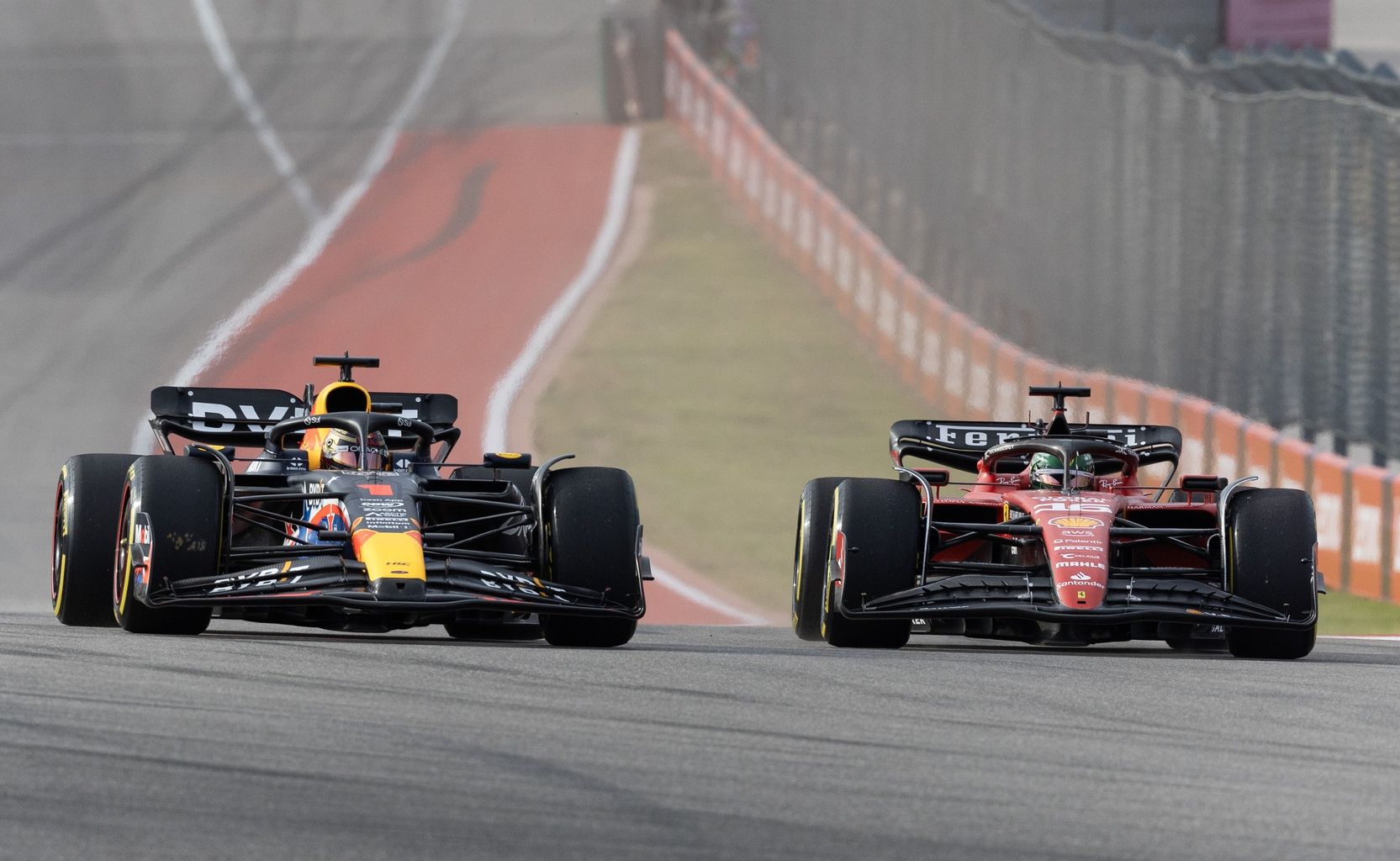 Max Verstappen of Red Bull Racing (1) and Charles Leclerc of Ferrari (16) are side by side at the start of the Sprint Race of the 2023 United States Grand Prix at Circuit of the Americas.