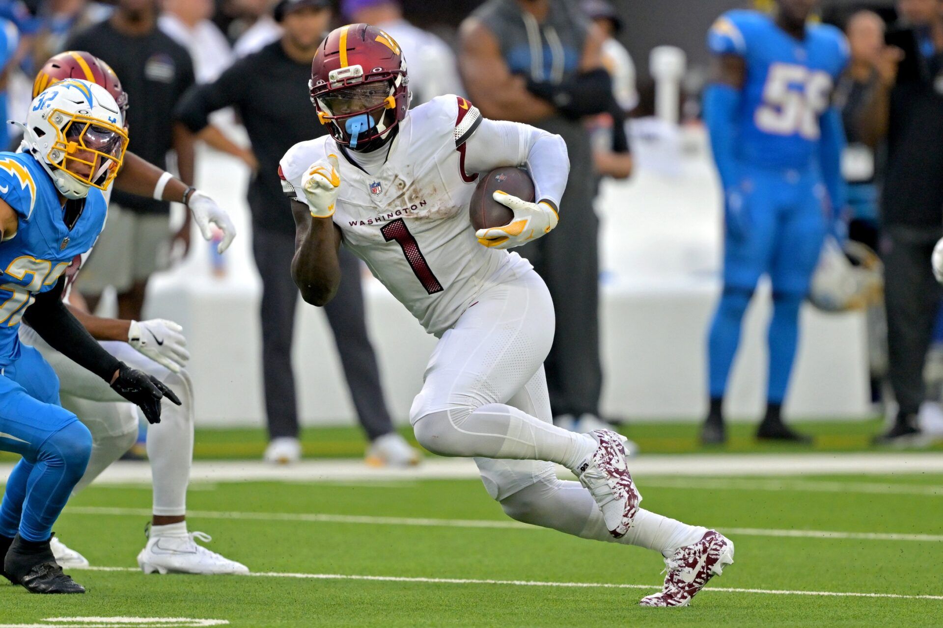 Washington Commanders wide receiver Deebo Samuel Sr. (1) runs against the Los Angeles Chargers at SoFi Stadium.