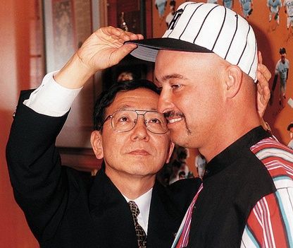 Shu Yamagata, the public relations director for the Hanshin Tigers, gives the team's hat to Alva's Mike Greenwell on 12-19-96. The former Boston Red Sox star signed with the Japanese team.