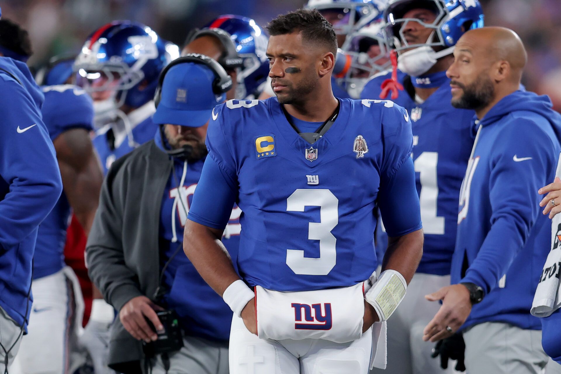 New York Giants quarterback Russell Wilson (3) watches from the sidelines during the second quarter against the Philadelphia Eagles at MetLife Stadium.