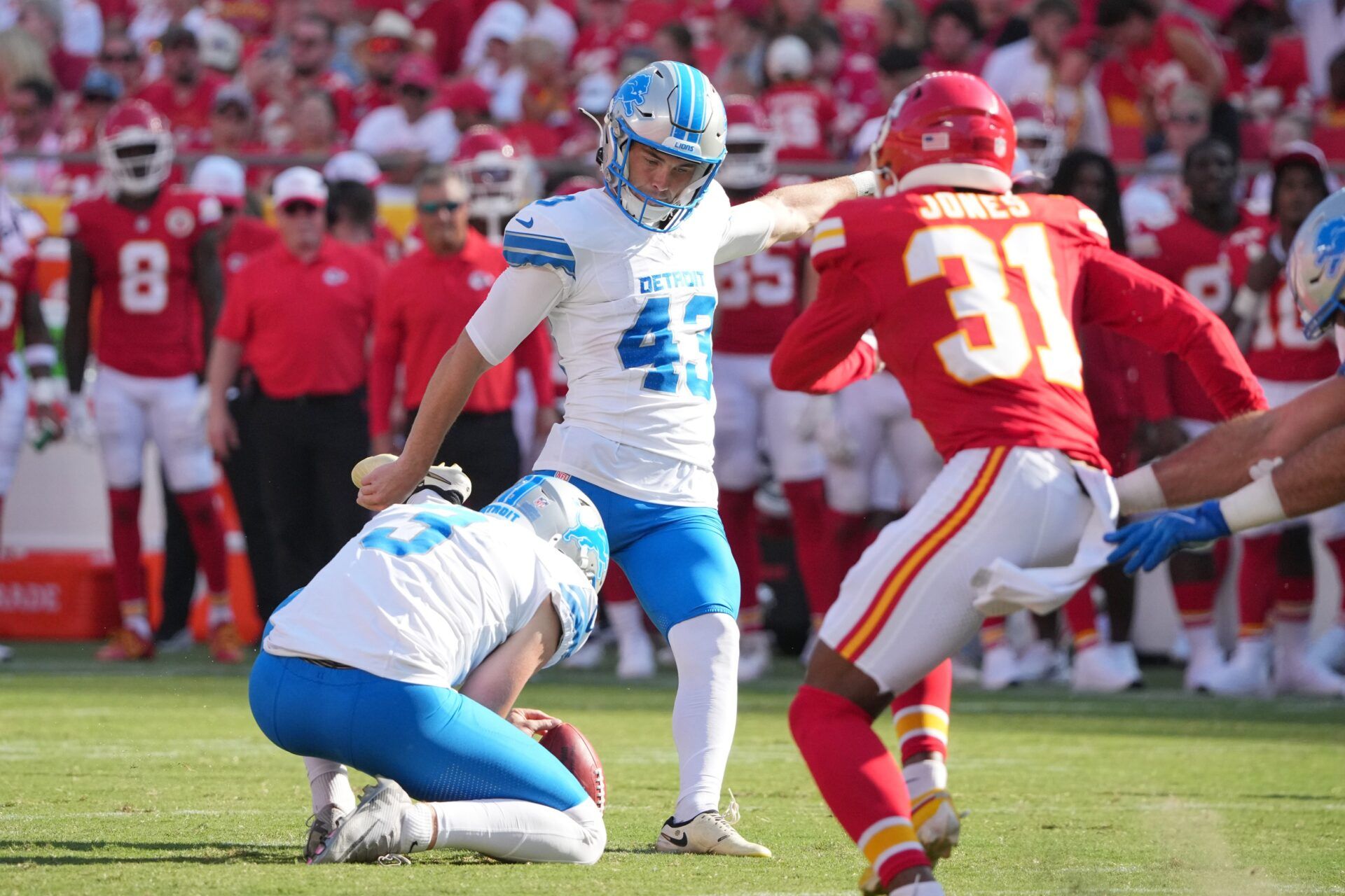 Detroit Lions kicker Jake Bates (43) kicks the point after touchdown against the Kansas City Chiefs during the second half at GEHA Field at Arrowhead Stadium.