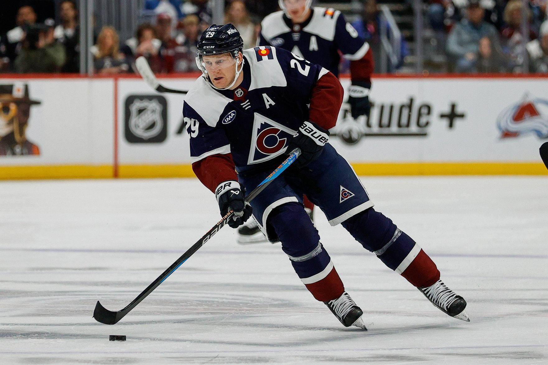 Colorado Avalanche center Nathan MacKinnon (29) controls the puck in the second period against the Dallas Stars at Ball Arena.