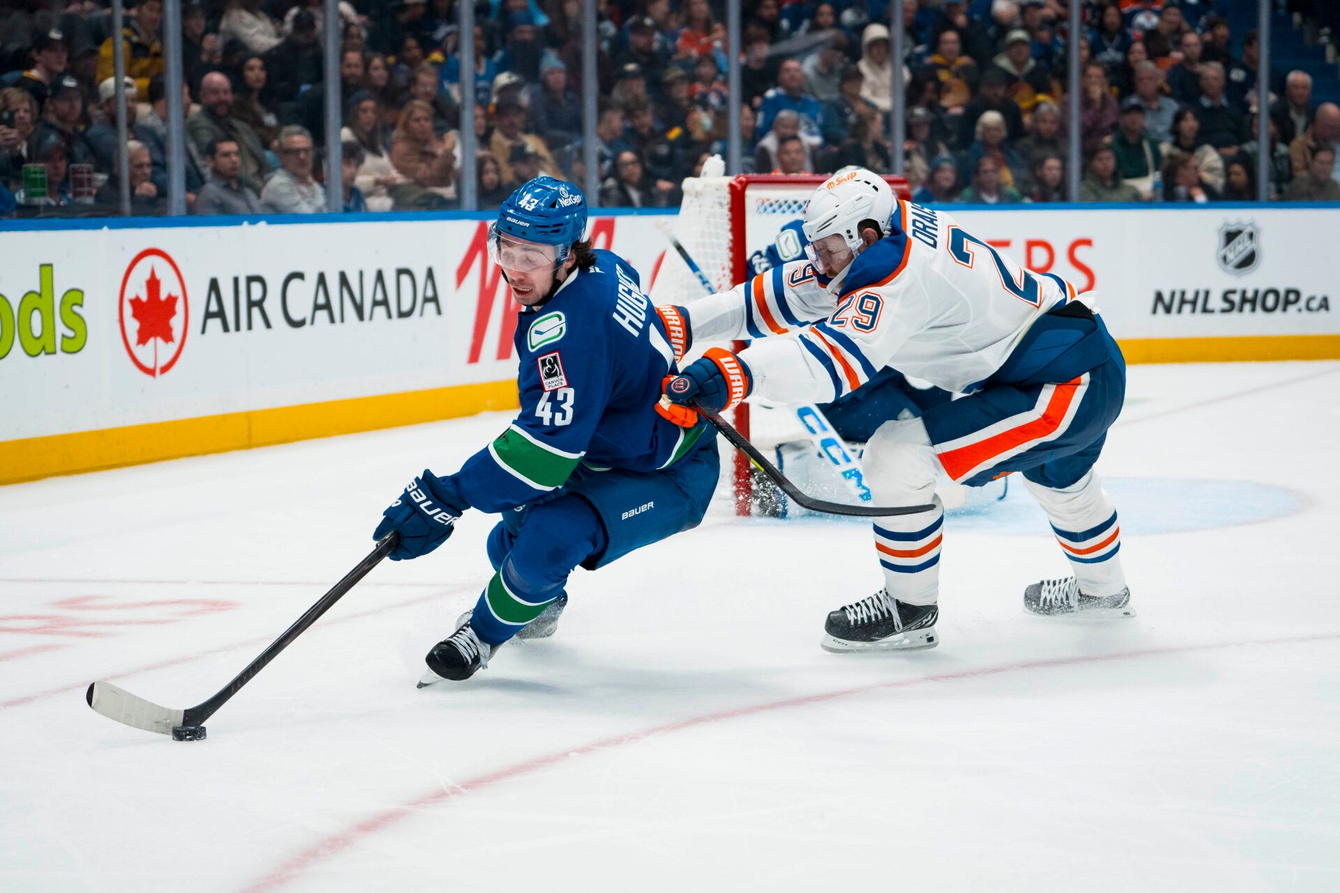 Edmonton Oilers forward Leon Draisaitl (29) checks Vancouver Canucks defenseman Quinn Hughes (43) in the second period at Rogers Arena.