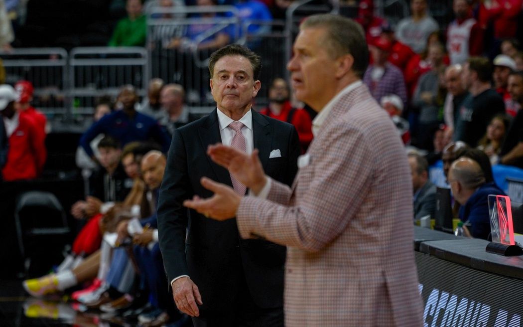 Coach Rick Pitino, left, approaches Coach John Calipari as their March Madness game is about to end on Saturday.