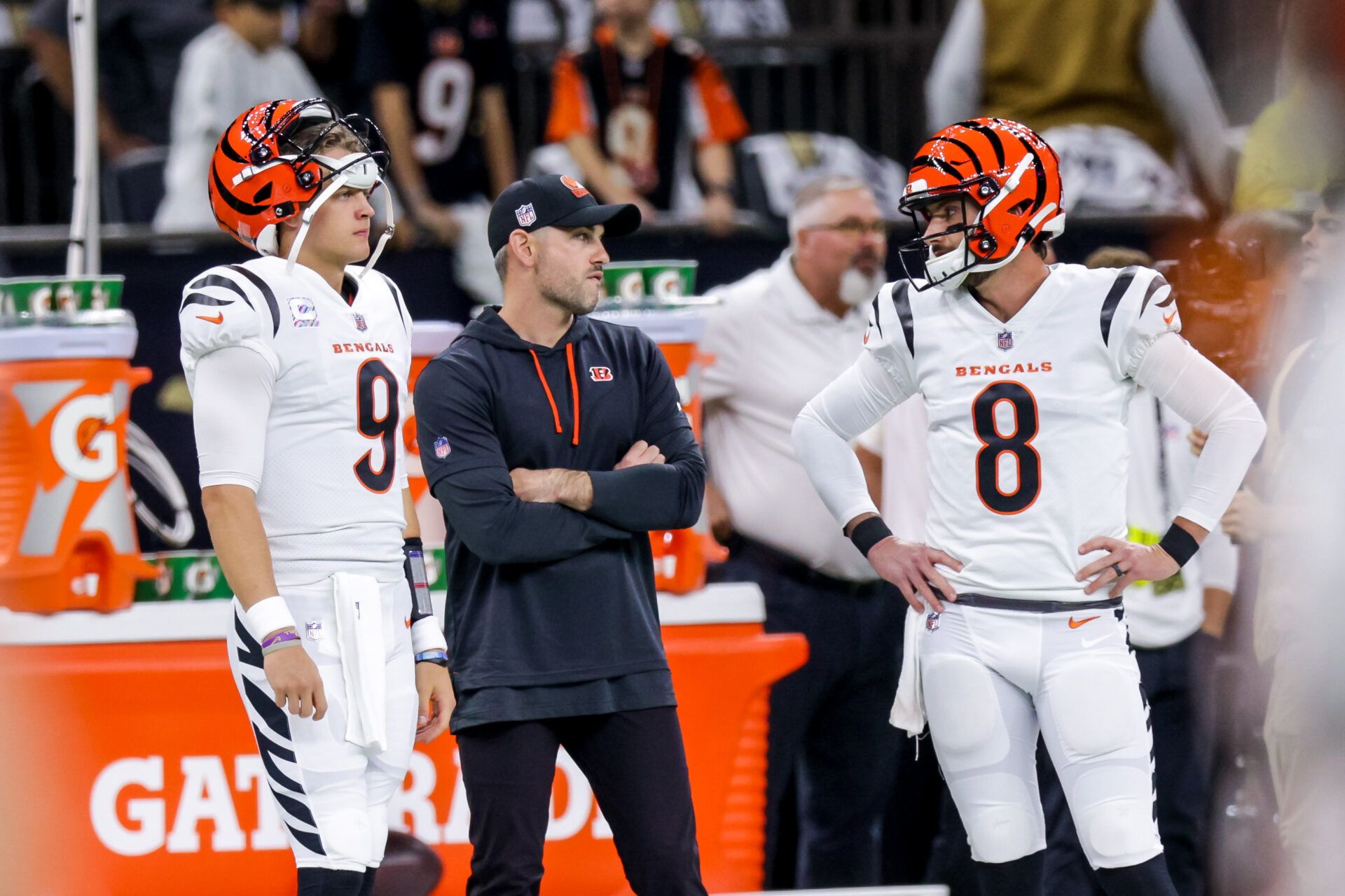 Cincinnati Bengals quarterback Joe Burrow (9) and quarterback Brandon Allen (8) talk to quarterback Jake Browning, center, during warm ups before the game against the New Orleans Saints at Caesars Superdome.