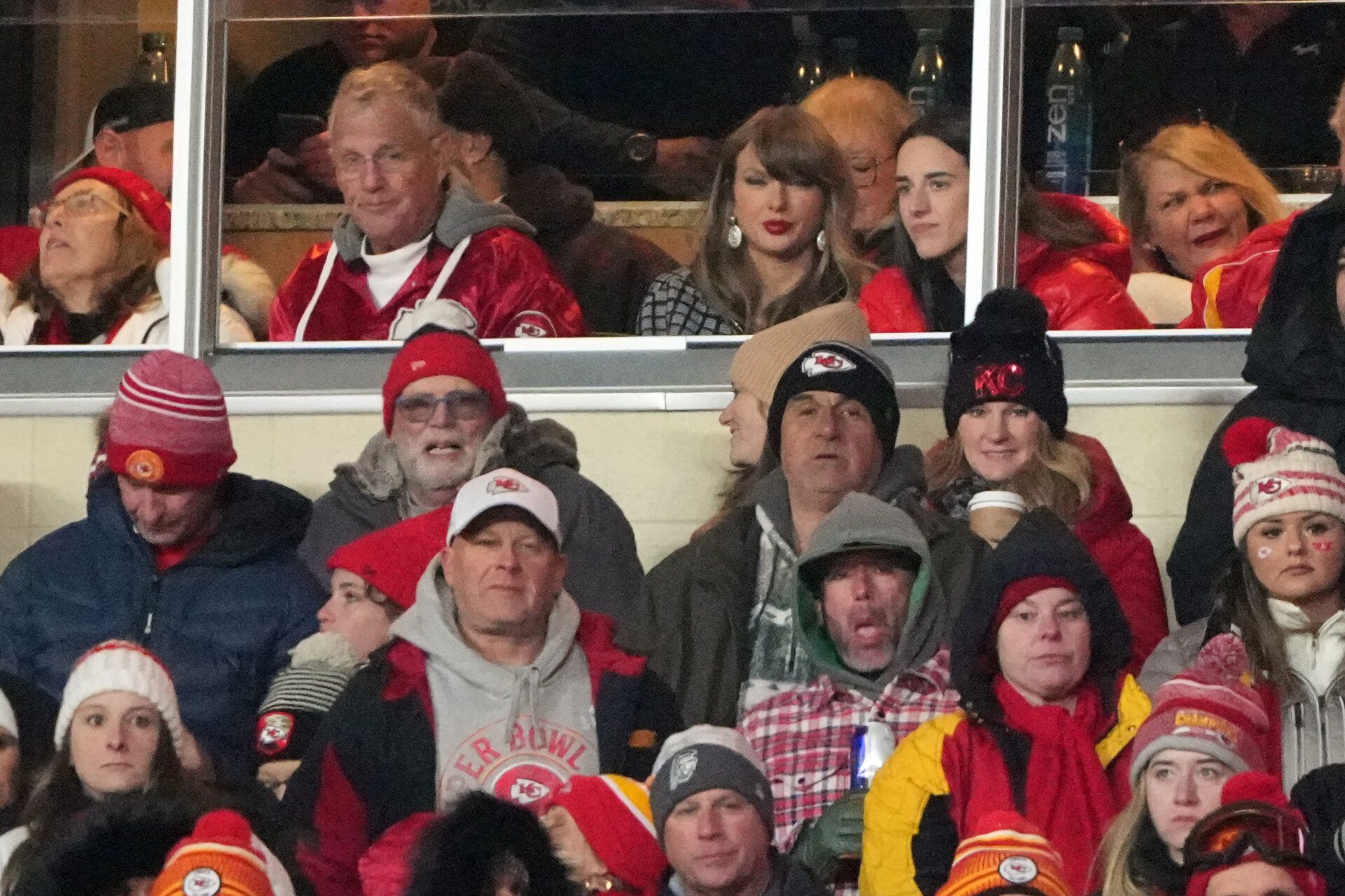 Recording artist Taylor Swift (upper middle) sits with Indiana Fever guard Caitlin Clark (upper right) during the fourth quarter of a 2025 AFC divisional round game between the Kansas City Chiefs and the Houston Texans at GEHA Field at Arrowhead Stadium.
