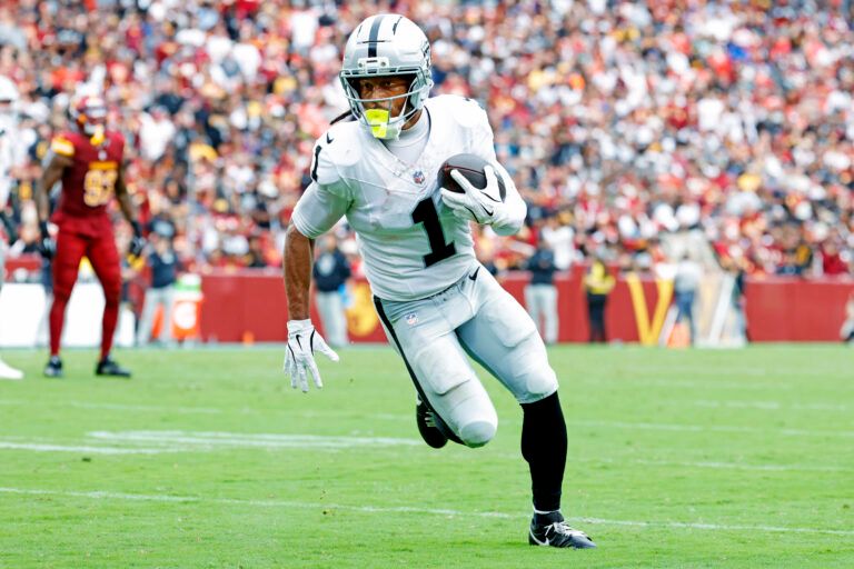Las Vegas Raiders wide receiver Tre Tucker (1) runs a touchdown pass during the second half against the Washington Commanders at Northwest Stadium.