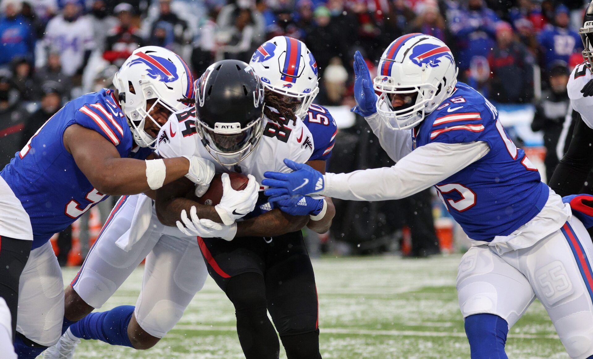 Bills defenders Ed Oliver (L-R) Greg Rousseau and Jerry Hughes team up to stop Falcons running back Cordarrelle Patterson.