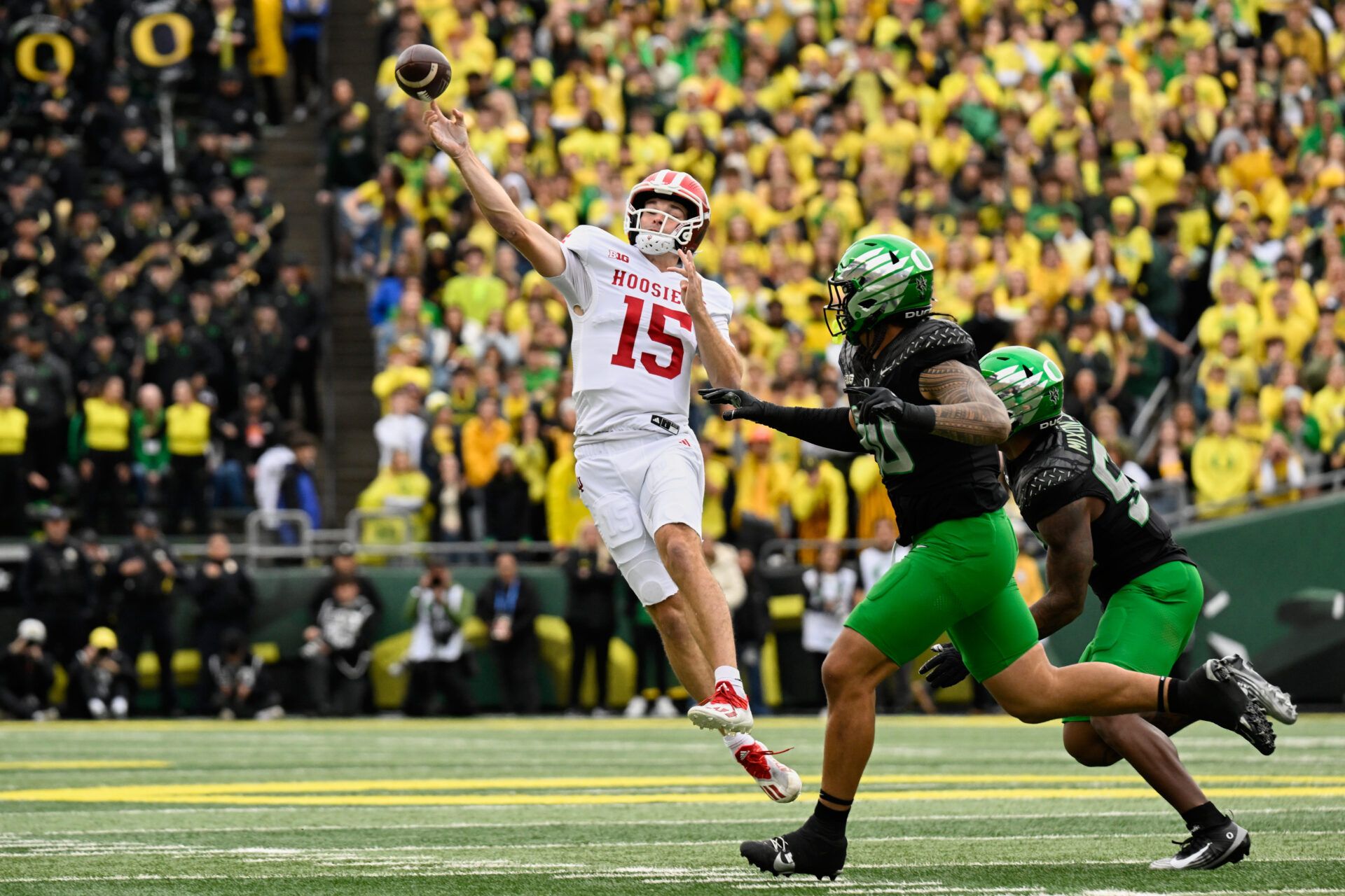 Indiana Hoosiers quarterback Fernando Mendoza (15) throws a pass against Oregon Ducks defensive back Xavier Barksdale (30) during the first quarter  at Autzen Stadium.