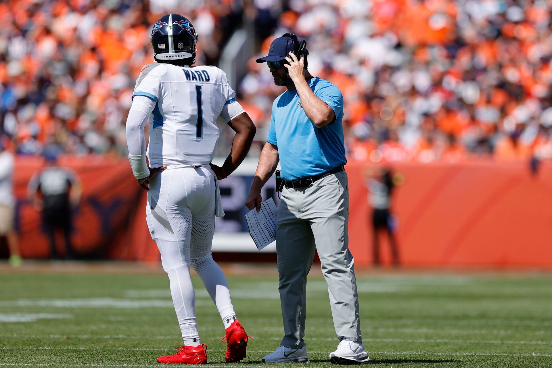 Tennessee Titans head coach Brian Callahan talks to quarterback Cam Ward (1) in the first half at Empower Field at Mile High.