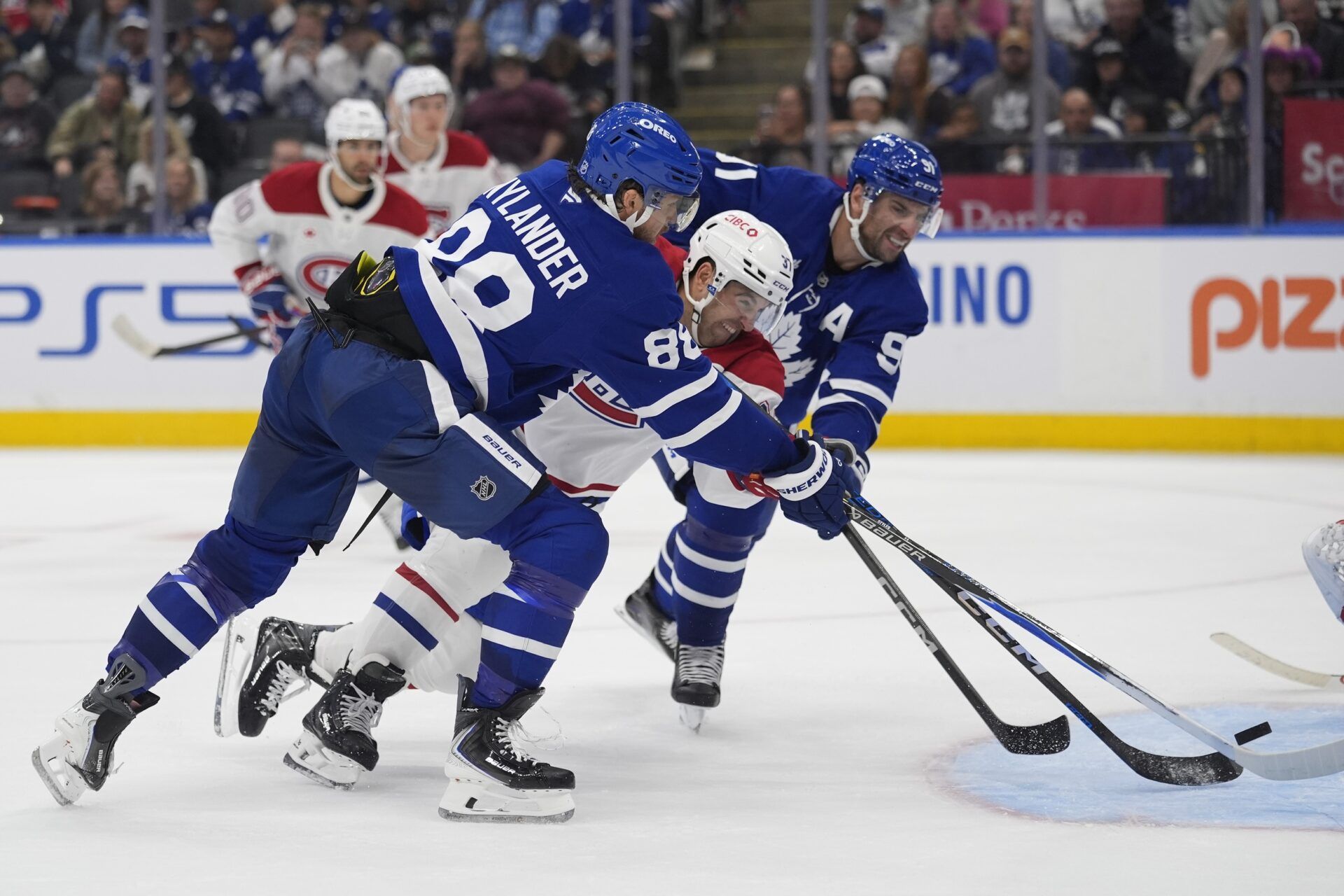 Toronto Maple Leafs forward William Nylander (88) scores against the Montreal Canadiens as Montreal Canadiens defenseman Marc Del Gaizo (37) and Toronto Maple Leafs forward John Tavares (91) battle for position during the third period at Scotiabank Arena.
