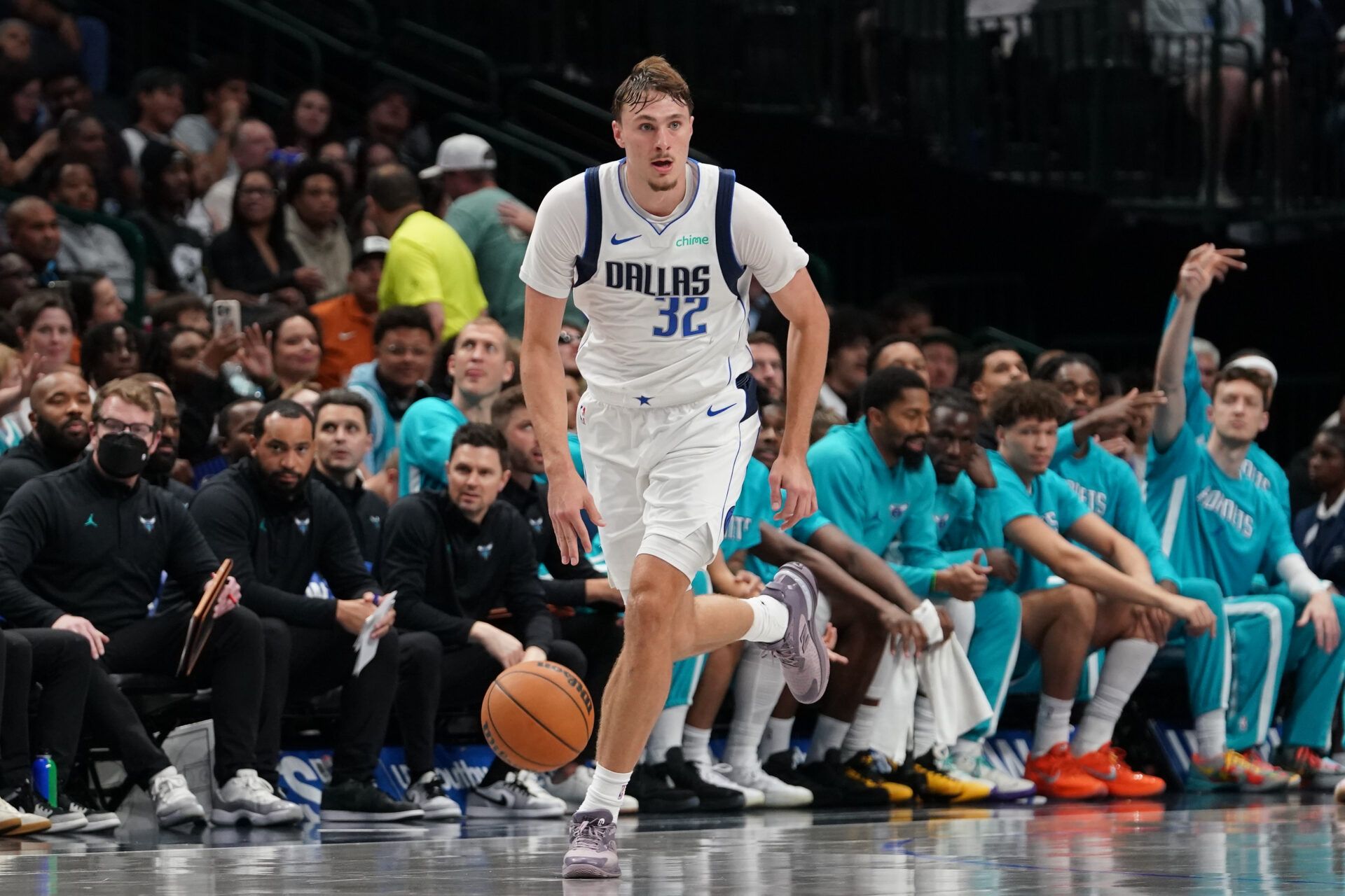 Dallas Mavericks forward Cooper Flagg (32) brings the ball up court against the Charlotte Hornets in the second half of a game at American Airlines Center.