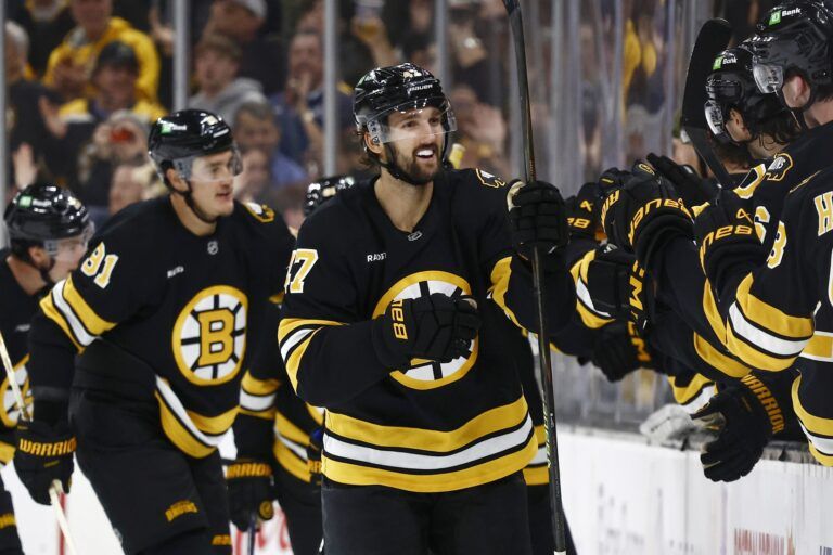 Boston Bruins center Mark Kastelic (47) is congratulated at the bench after scoring against the Buffalo Sabres during the second period at TD Garden.