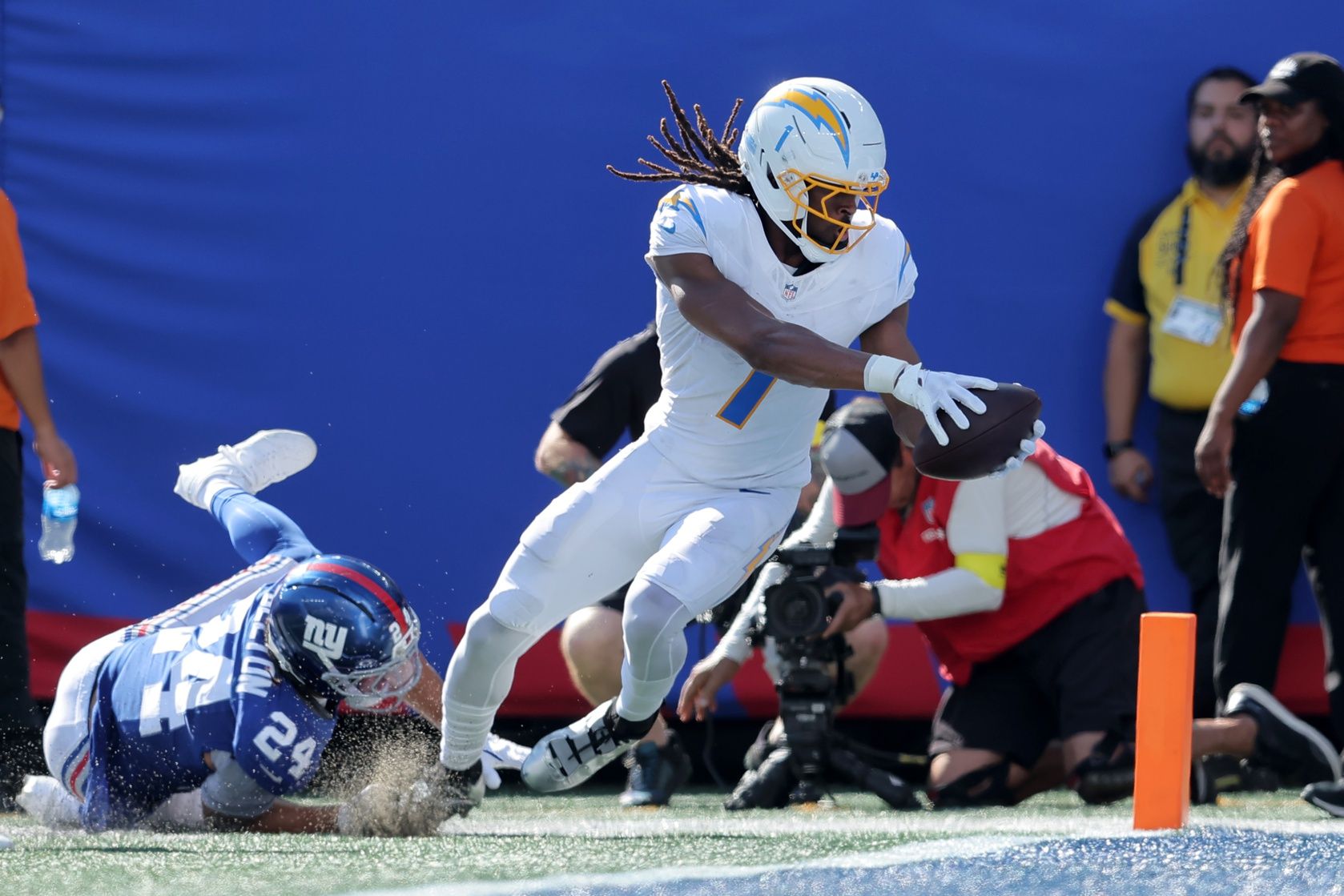 Los Angeles Chargers wide receiver Quentin Johnston (1) scores a touchdown against New York Giants safety Dane Belton (24) during the second quarter at MetLife Stadium.