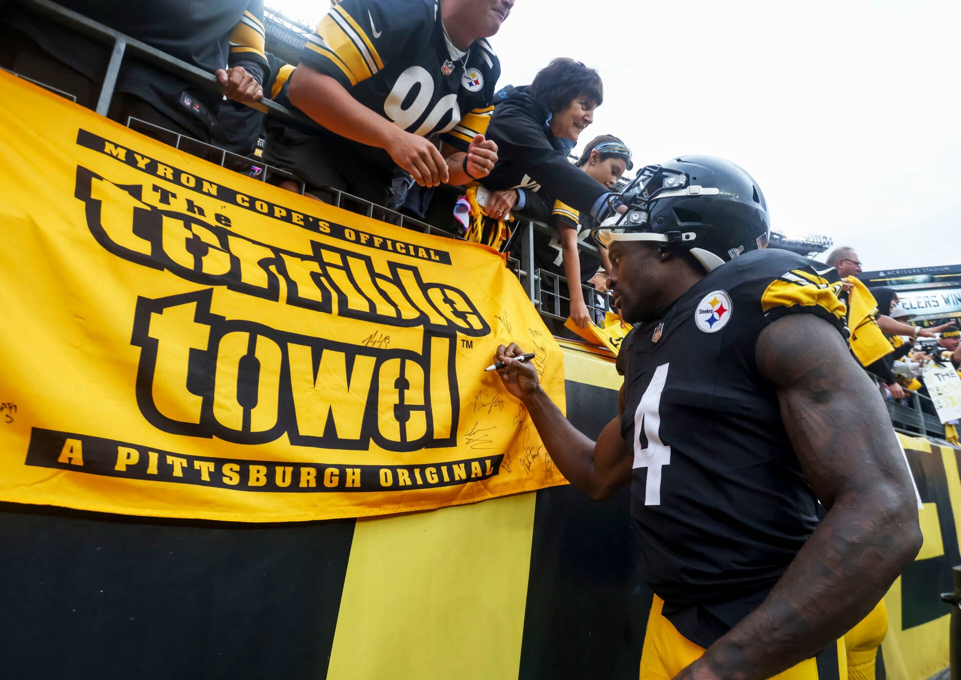 Pittsburgh Steelers wide receiver DK Metcalf (4) signs a fan’s terrible towel after the game at Acrisure Stadium.