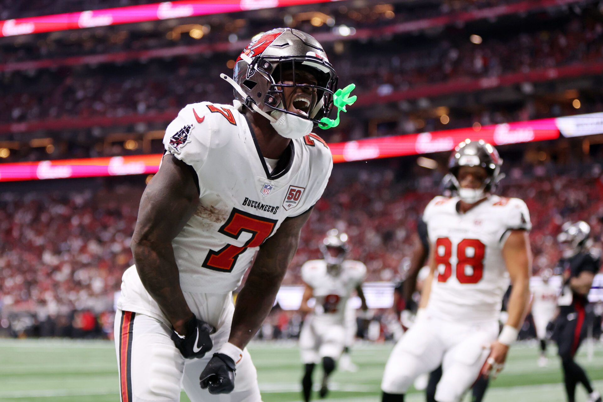 Tampa Bay Buccaneers running back Bucky Irving (7) celebrates after scoring a touchdown against the Atlanta Falcons during the third quarter at Mercedes-Benz Stadium.