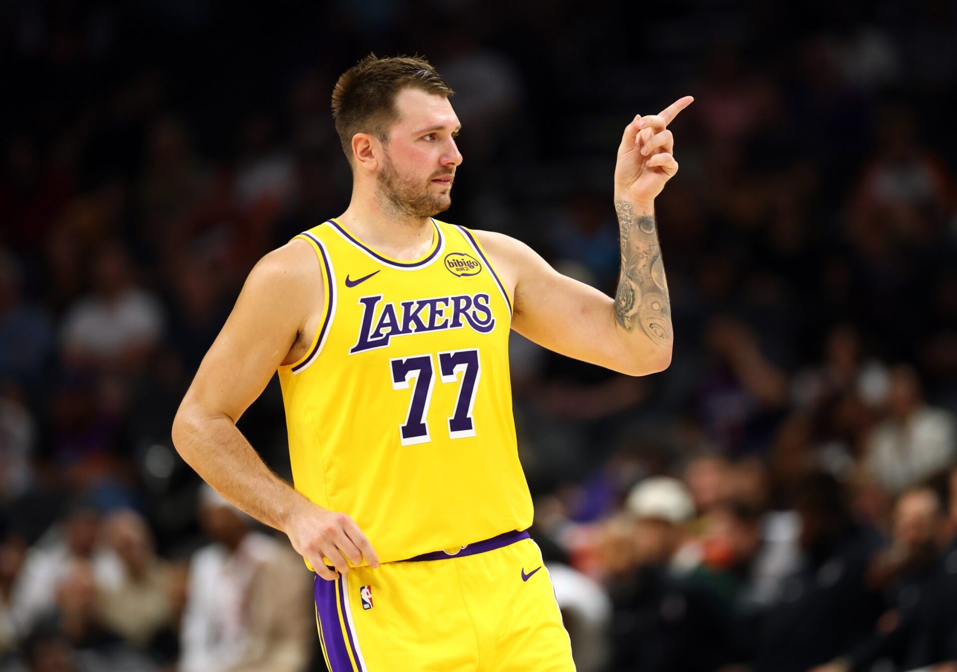 Los Angeles Lakers guard Luka Doncic (77) reacts against the Phoenix Suns during an NBA preseason game at Mortgage Matchup Center.