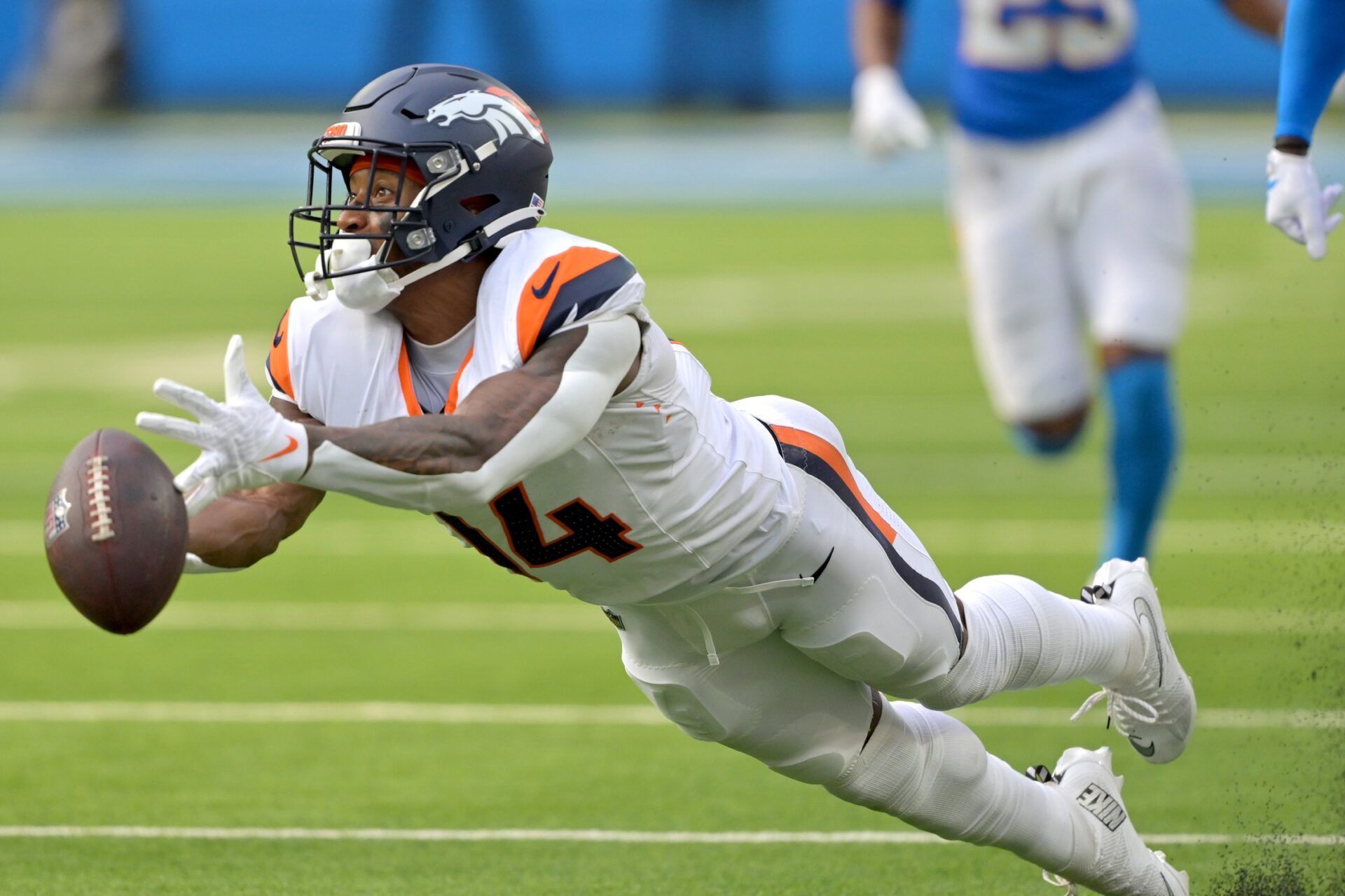 Denver Broncos wide receiver Courtland Sutton (14) reaches for a long pass 4th down in the second half against the Los Angeles Chargers at SoFi Stadium.