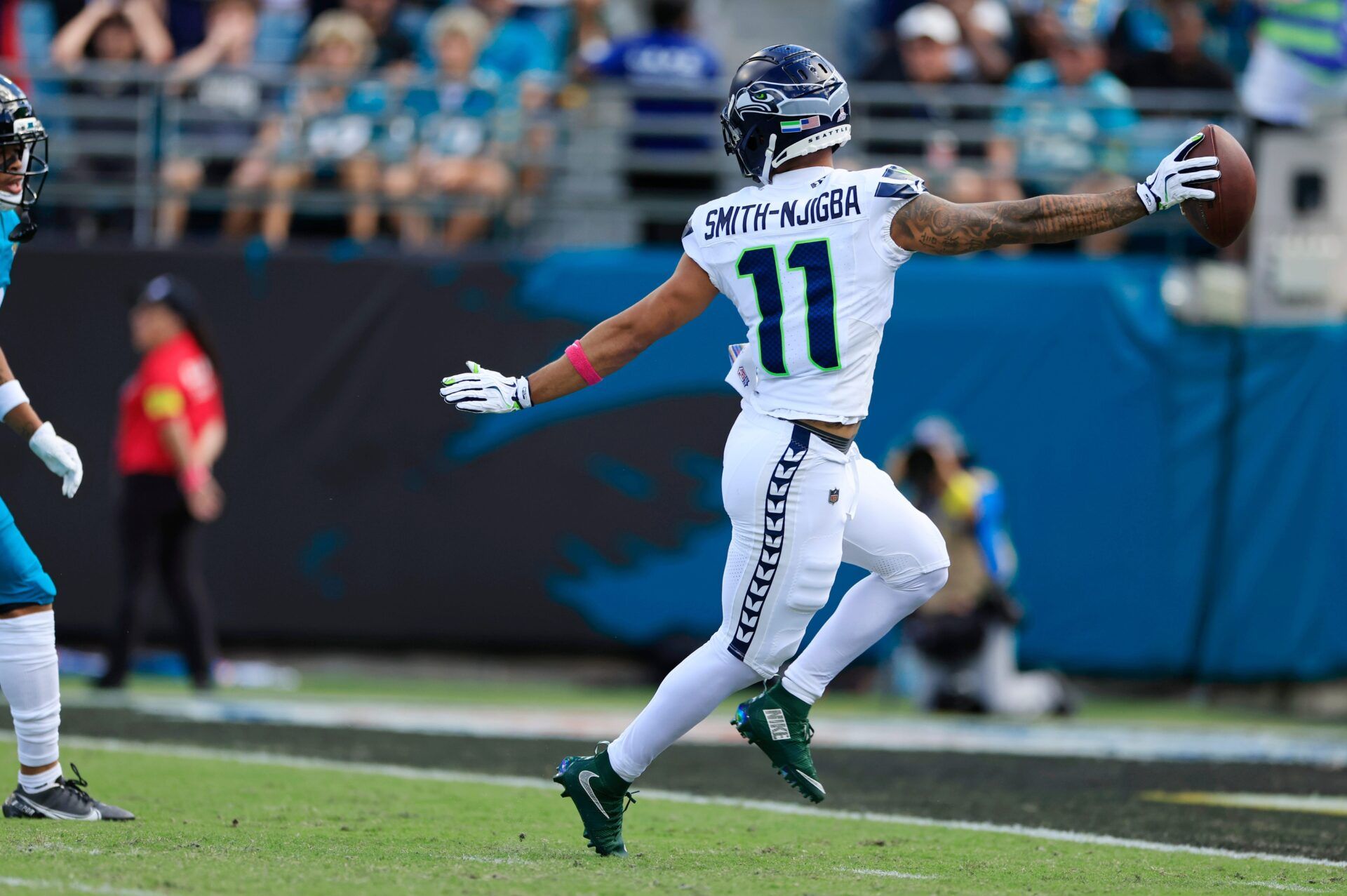 Seattle Seahawks wide receiver Jaxon Smith-Njigba (11) looks back at Jacksonville Jaguars cornerback Greg Newsome II (6) while scoring a touchdown during the second quarter of an NFL football matchup, Sunday, Oct. 12, 2025, at EverBank Stadium in Jacksonville, Fla. The Seahawks defeated the Jaguars 20-12.