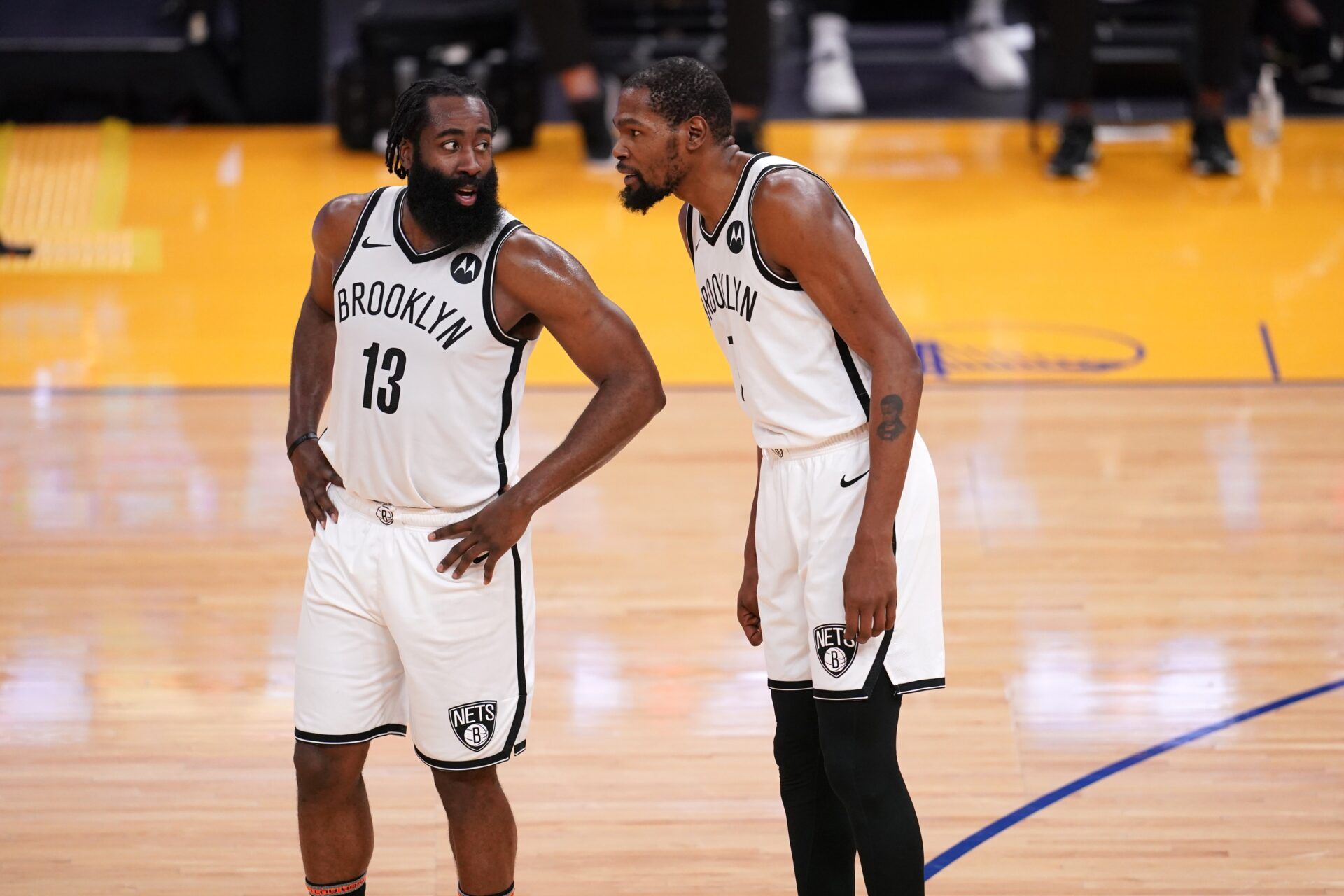 Brooklyn Nets guard James Harden (13) talks with forward Kevin Durant (7) during a free throw attempt by the Nets against the Golden State Warriors in the third quarter at the Chase Center.