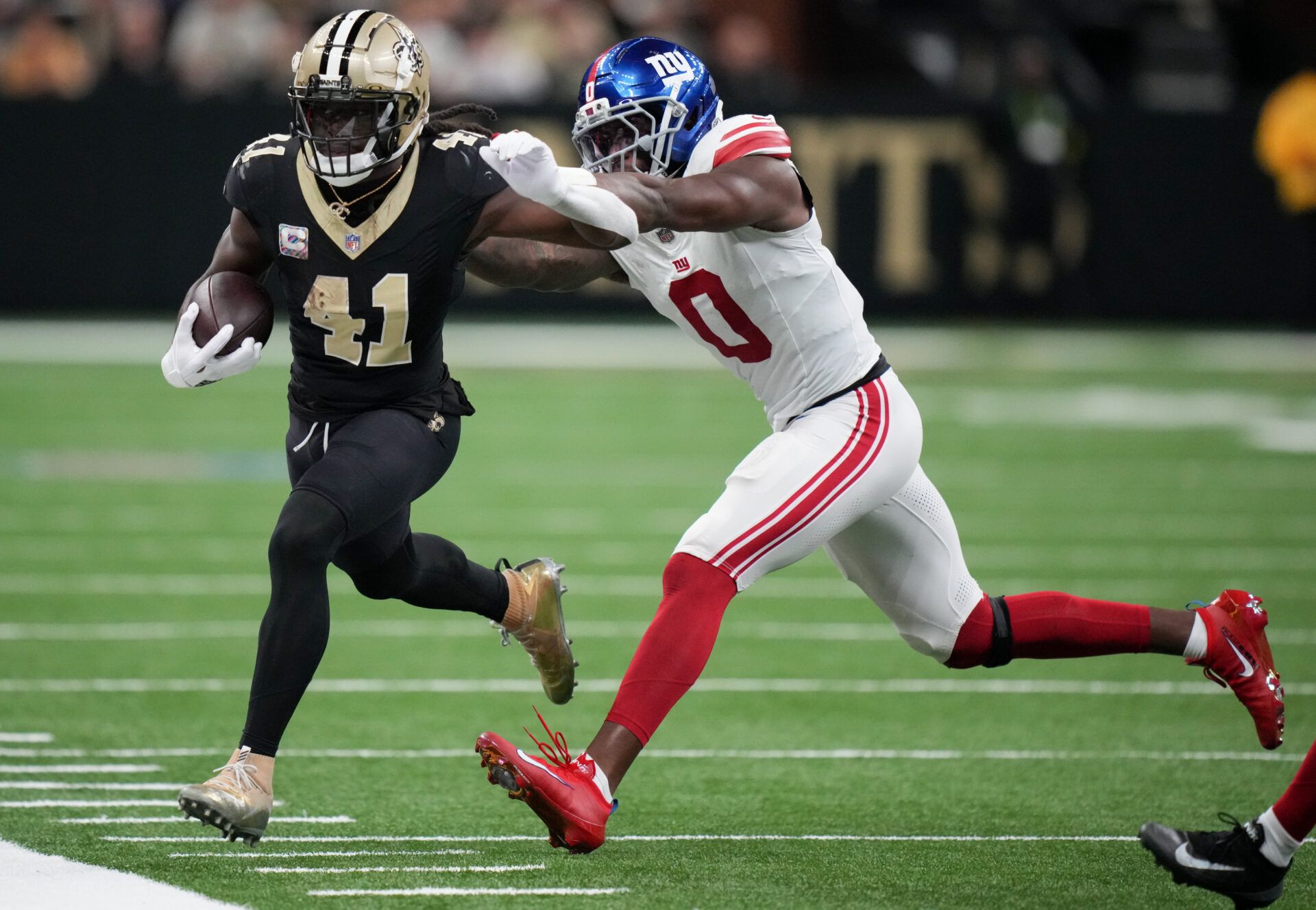 New Orleans Saints running back Alvin Kamara (41) runs the ball against New York Giants linebacker Brian Burns (0) at Caesars Superdome.