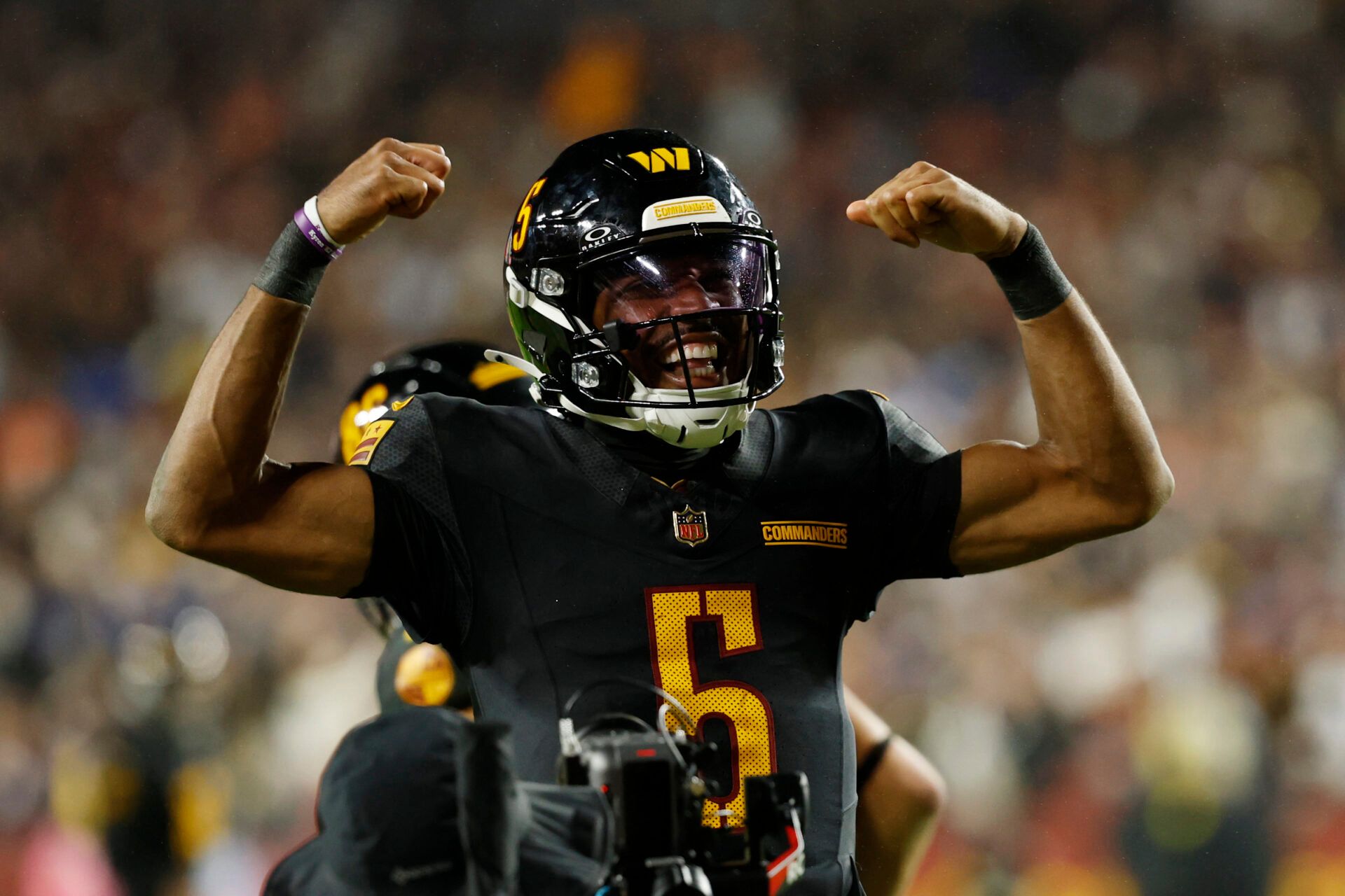 Washington Commanders quarterback Jayden Daniels (5) reacts after a play against the Chicago Bears during the second half at Northwest Stadium.