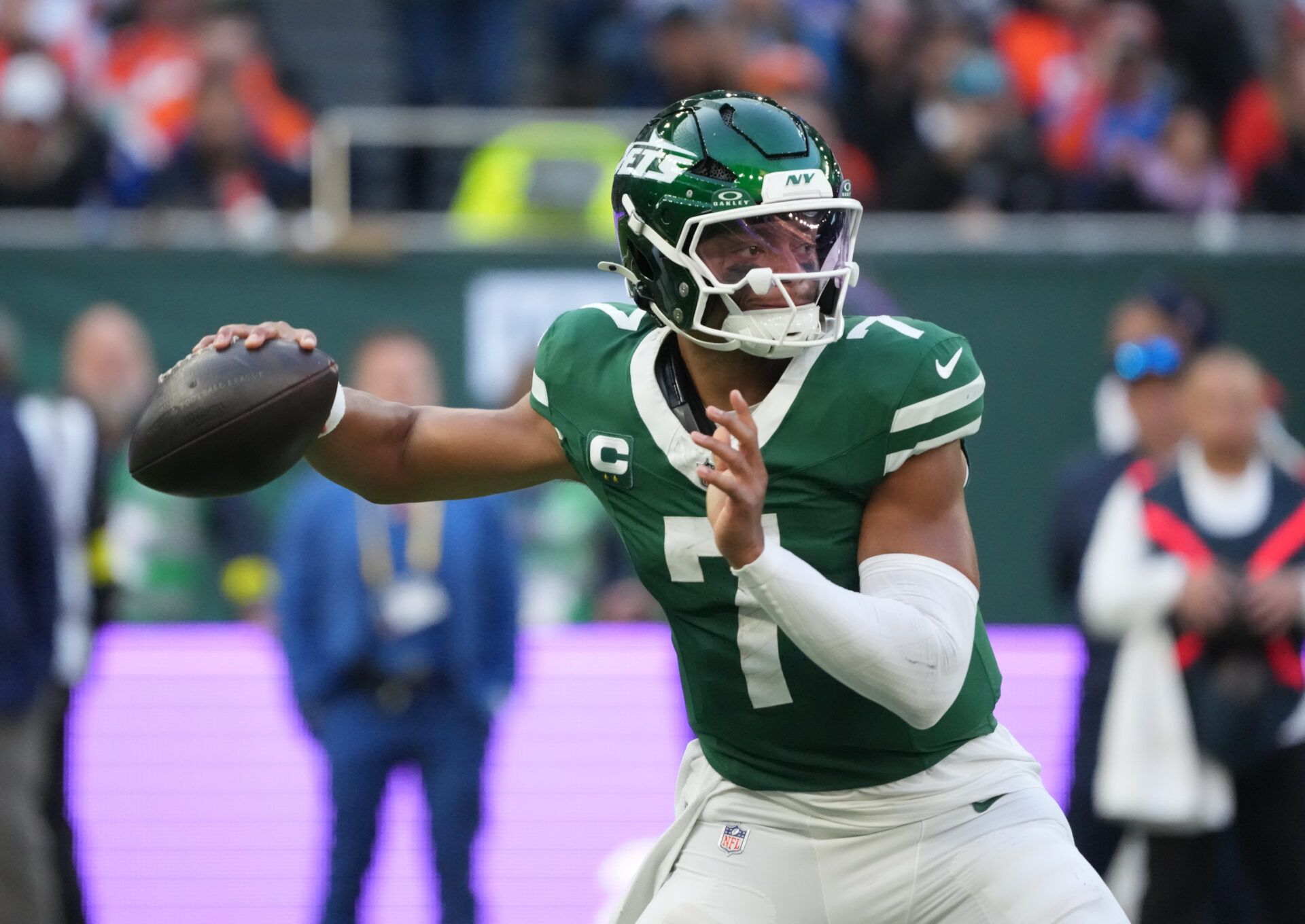 New York Jets quarterback Justin Fields (7) throws a pass against the Denver Broncos during an NFL International Series game at Tottenham Hotspur Stadium.