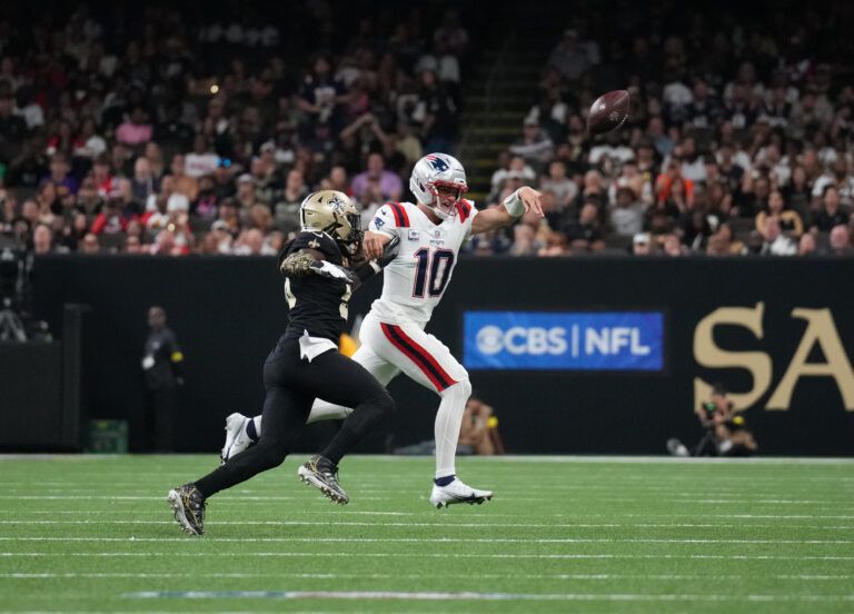 New England Patriots quarterback Drake Maye (10) throws downfield past New Orleans Saints outside linebacker Demario Davis (56) during the second quarter at Caesars Superdome.