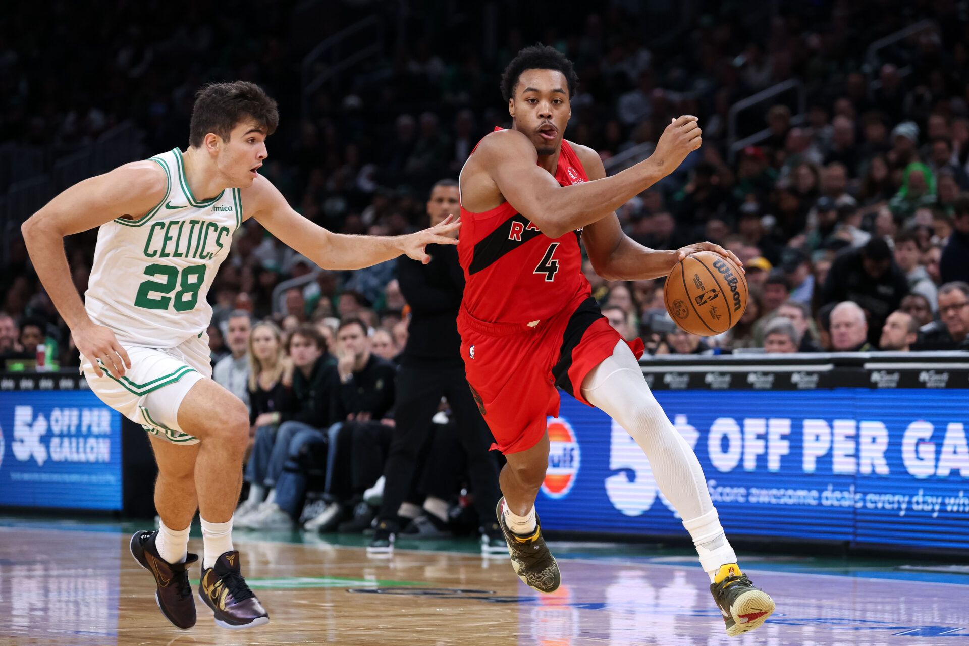 Toronto Raptors guard Scottie Barnes (4) drives to the basket during the second half against the Boston Celtics at TD Garden.