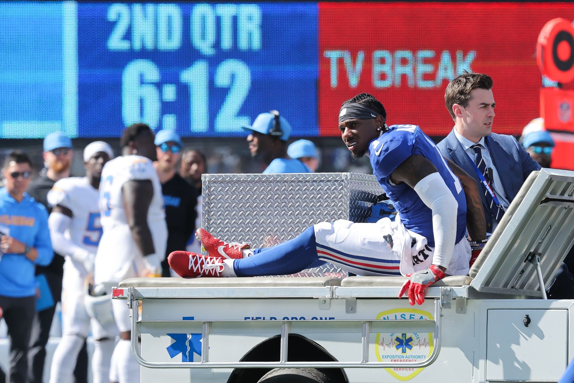 New York Giants wide receiver Malik Nabers (1) is carted off the field following an injury during the second quarter against the Los Angeles Chargers at MetLife Stadium.