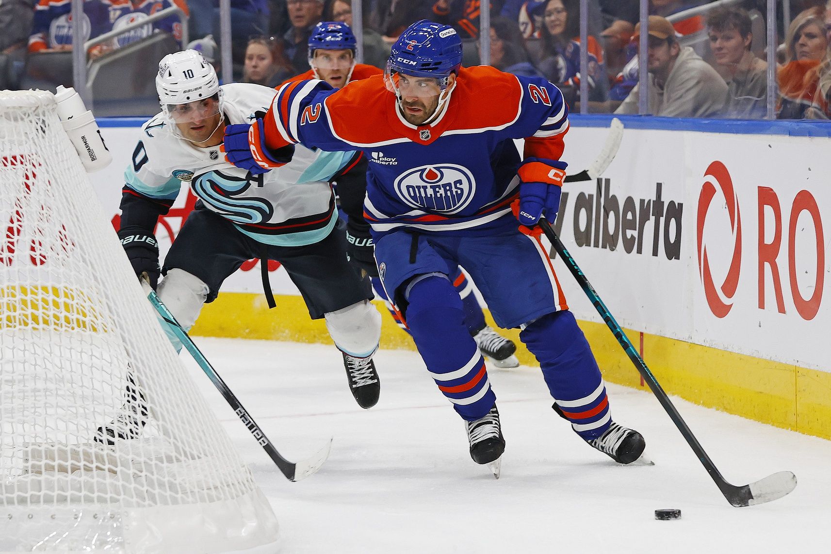 Edmonton Oilers defensemen Evan Bouchard (2) moves the puck in front of Seattle Kraken forward Matty Beniers (10) during the second period at Rogers Place.