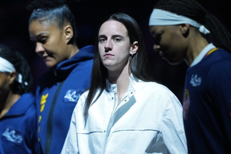 Indiana Fever guard Caitlin Clark (center) stands on the court before the game against the Golden State Valkyries at Chase Center.