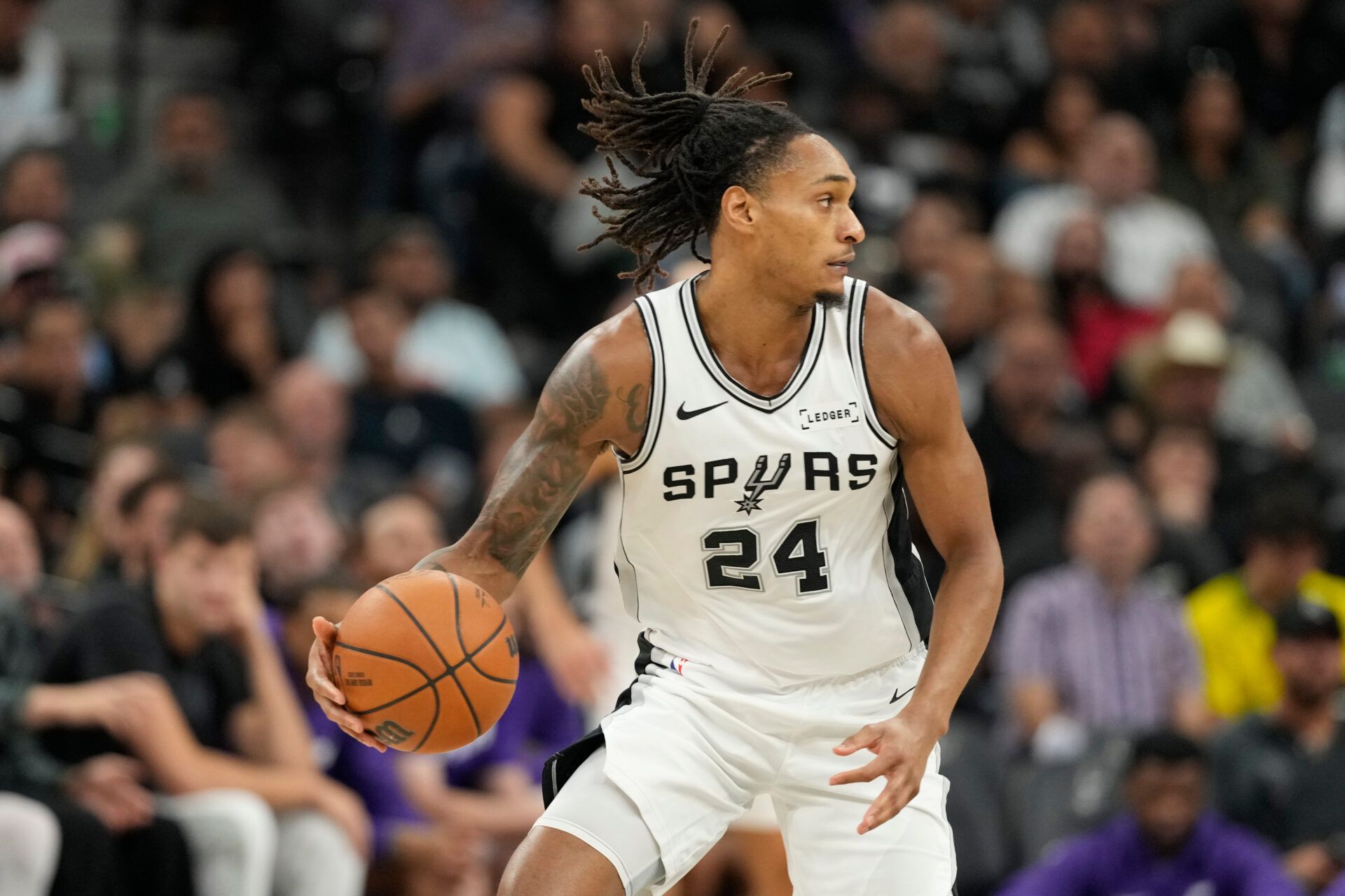 San Antonio Spurs guard Devin Vassell (24) looks to pass the ball during the first half against the Utah Jazz at Frost Bank Center.