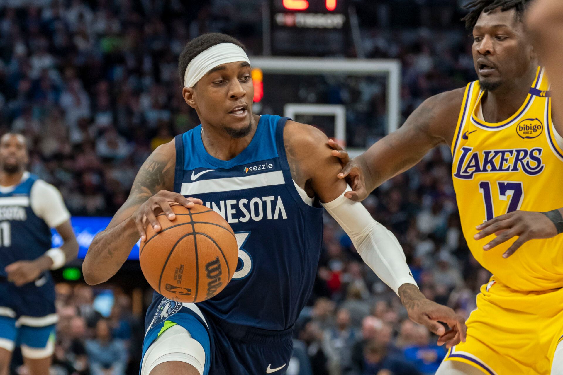Minnesota Timberwolves forward Jaden McDaniels (3) dribbles the ball as Los Angeles Lakers forward Dorian Finney-Smith (17) plays defense in the second half during game three of first round for the 2024 NBA Playoffs at Target Center.