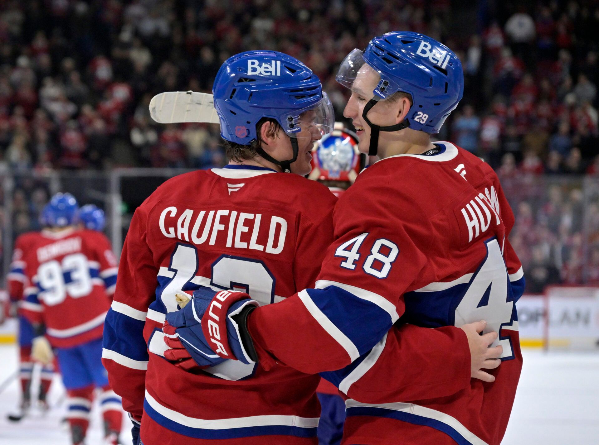 Montreal Canadiens forward Cole Caufield (13) celebrates with teammate defenseman Lane Hutson (48) after scoring the winning goal against the Seattle Kraken during the overtime period at the Bell Centre.